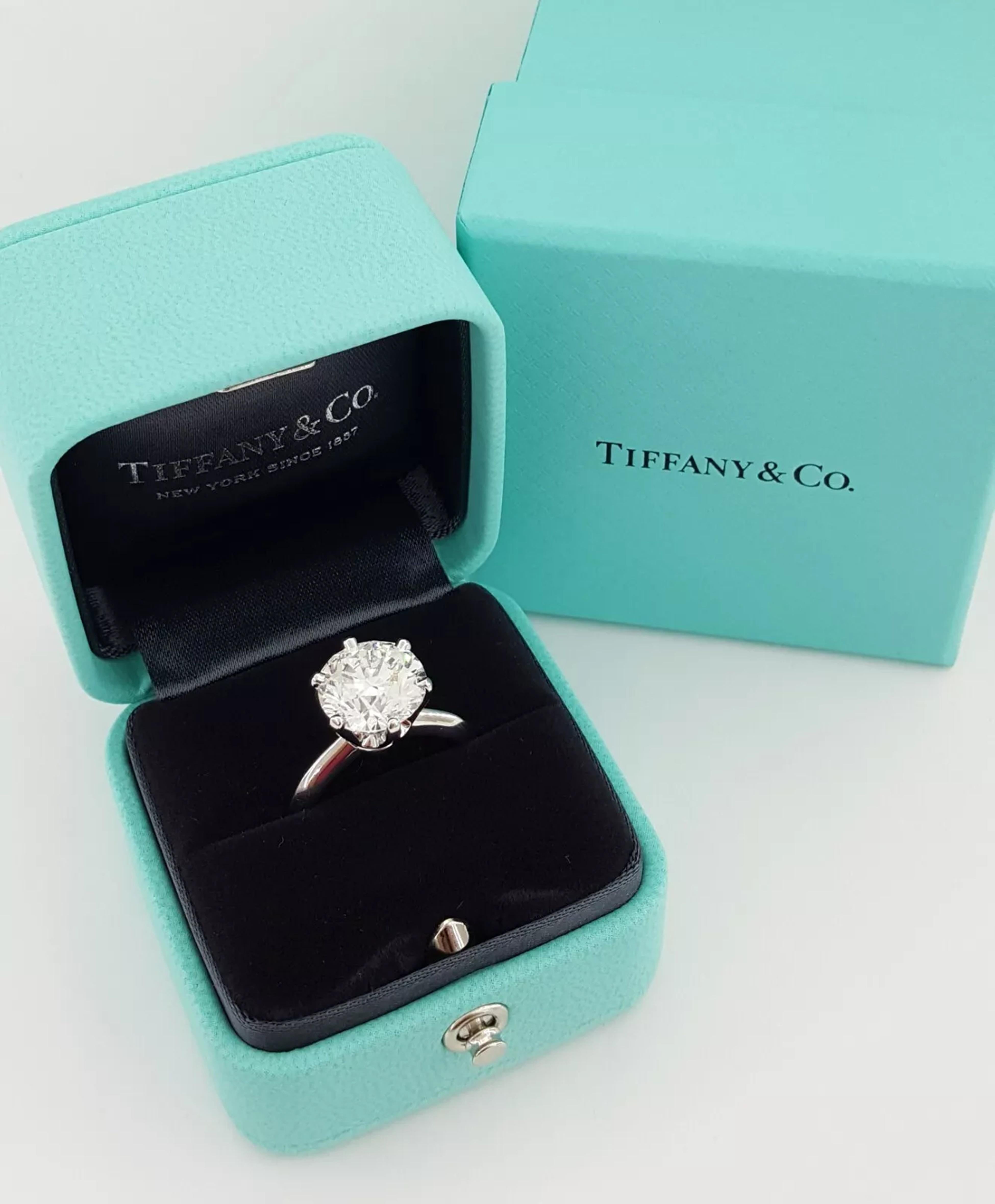Tiffany & Co. Round Brilliant Cut Diamond Solitaire Engagement Ring is a stunning and significant piece, featuring a total carat weight of 4.49 carats. The center diamond, weighing 4.49 carats, is natural and boasts a G color grade, indicating it is