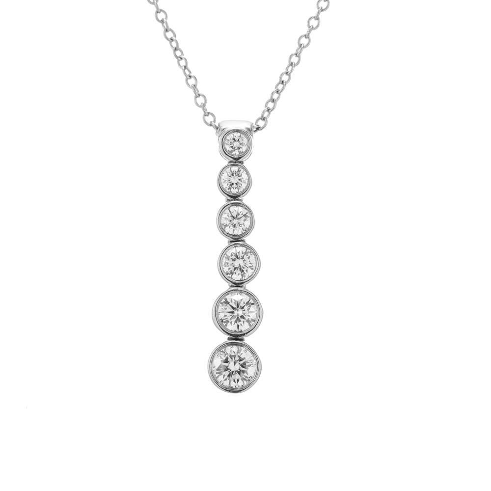 From Tiffany & Co's Jazz Collection. This necklace is crafted in platinum and features a graduated drop pendant with 6 bezel set diamonds. Tiffany hallmark on pendant and 16 inch chain.

6 round brilliant cut diamonds, F-G VS approx. .45cts
Platinum