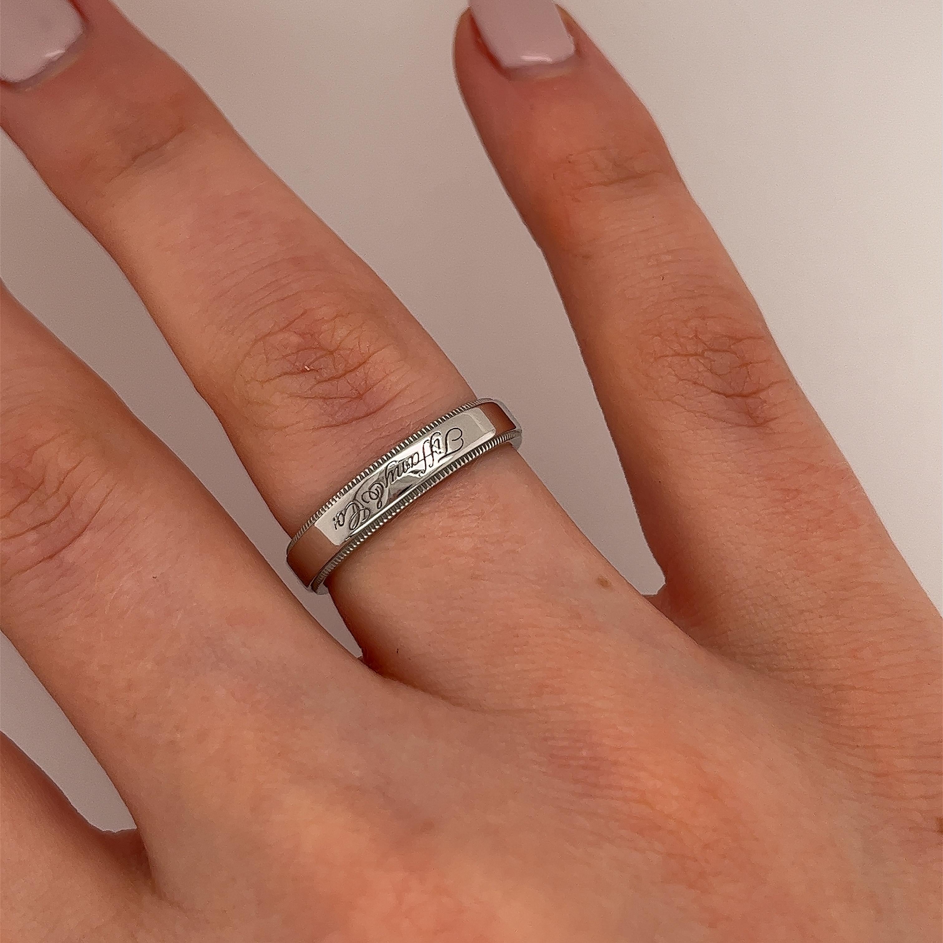 Tiffany & Co. 4mm Together Platinum Milgrain Edge Wedding Ring is a meaningful and enduring symbol of the bond shared between two individuals. Its classic design, superior craftsmanship, and timeless elegance make it a treasured heirloom for