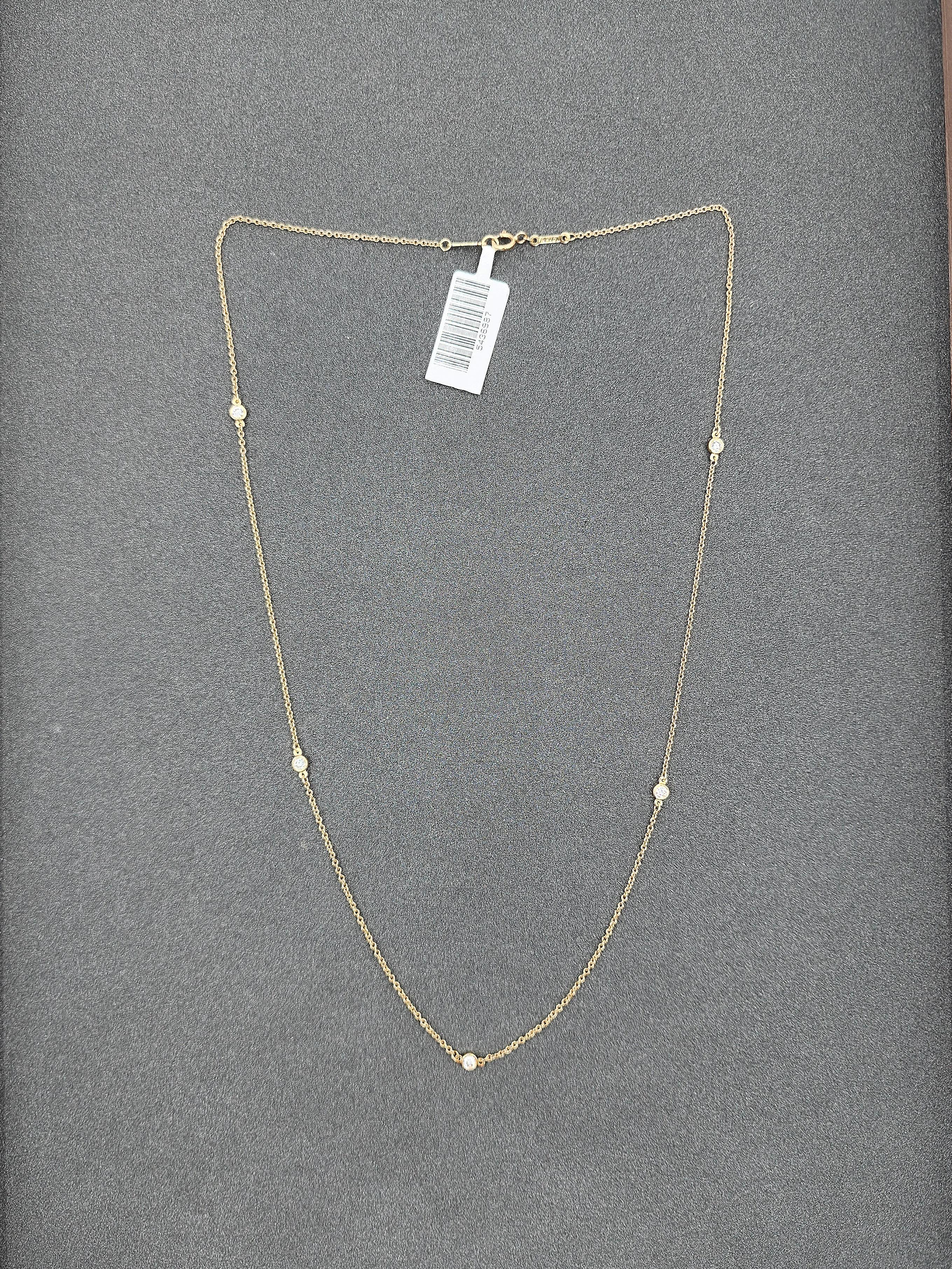 This elegant necklace by Tiffany & Co. features a refined design with a focus on simplicity and sophistication. The piece is adorned with 5 round white diamonds, totaling 0.3 carats, each with an F/G color grade and VS1/VS2 clarity. Crafted from 18k
