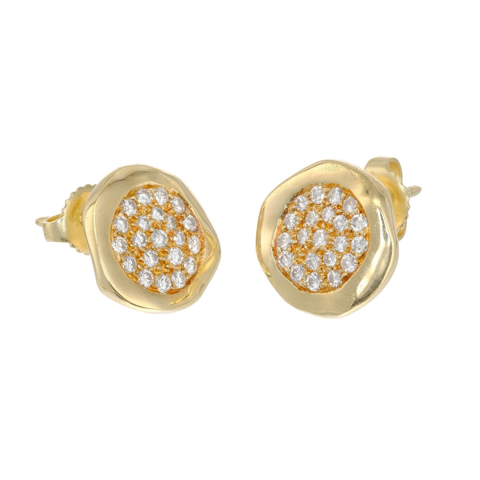 1980 Tiffany Diamond earrings, Pave set Diamonds in center of a slightly hammered edge circles of 18K yellow gold.

42 Round Brilliant Cut Diamonds, Approximate 0.50ct Total, G-H Color, VS Clarity.
18k Yellow Gold
Stamped: 18K
Tested: 18K
Hallmark: