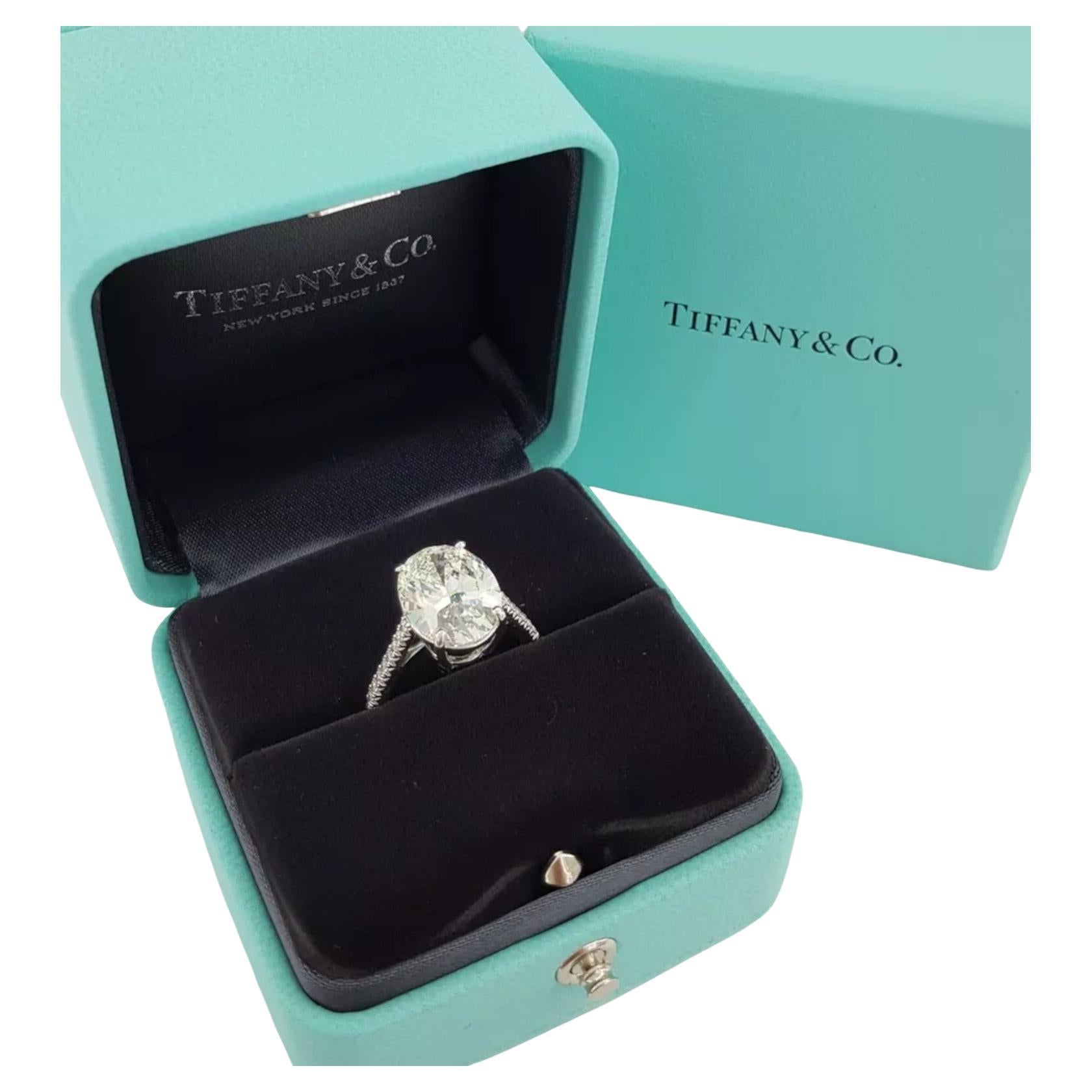 Tiffany & Co. Novo engagement ring is an exceptional piece of jewelry.  A stunning oval brilliant-cut diamond serves as its centerpiece, graded as a natural diamond with a nearly colorless hue, and exhibiting exceptional clarity, cut, polish, and