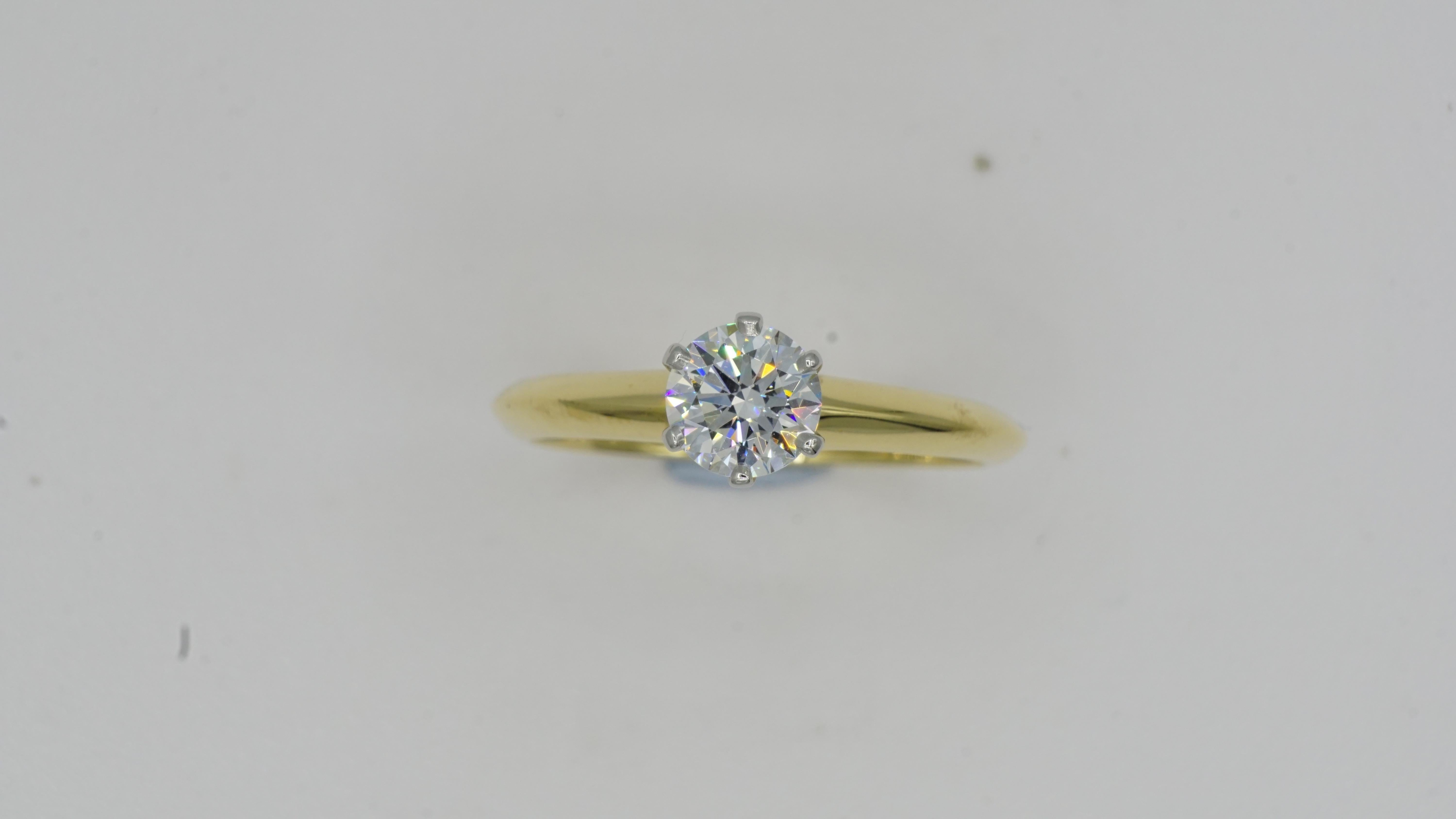 Tiffany & Co. .60ct Round Brilliant Diamond G/VVS1 Platinum 18kt Yellow Gold 6 Prong Solitaire Size 6. This comes with a Tiffany and Co Certificate.
This is a set and can be sold separately if desired.
The engagement ring weighs 2.9 grams total and
