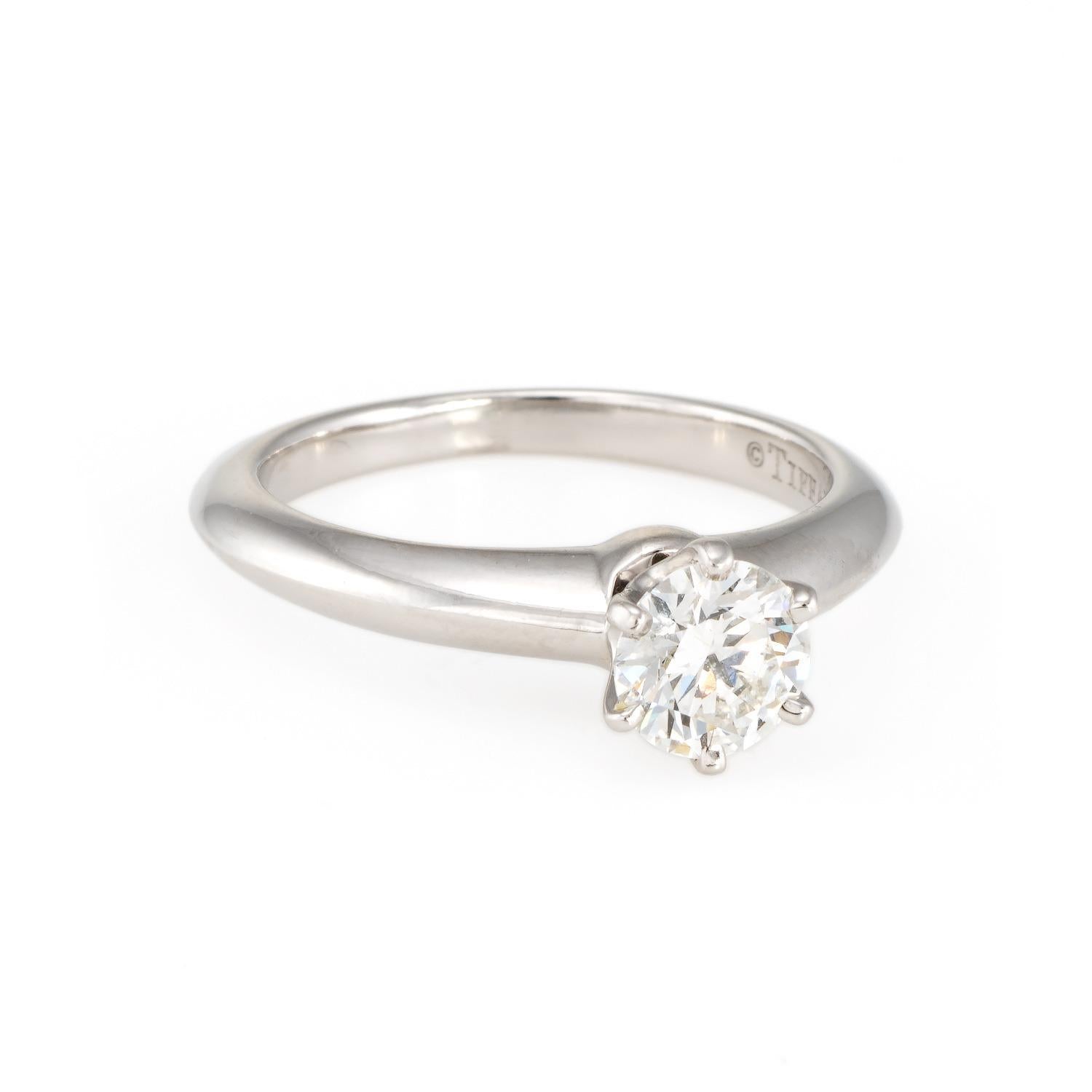 Elegant pre owned Tiffany & Co diamond solitaire engagement ring, crafted in 950 platinum. 

Round brilliant cut diamond measures 5.56 - 5.59 x 3.36mm (0.64 carats). The diamond is graded F color and SI1 clarity.

The classic 'Tiffany Setting' ring