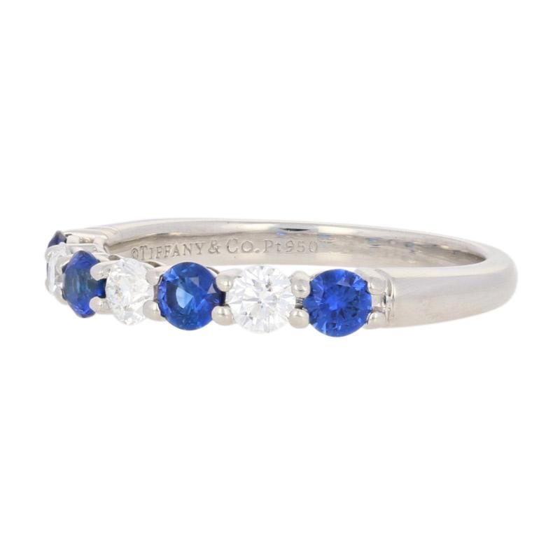 Celebrate life’s special milestones with the gift of Tiffany & Co. jewelry! Created in heirloom-quality 950 platinum, this sophisticated Embrace band sparkles with vibrant blue sapphires and glittering white diamonds. This designer ring originally