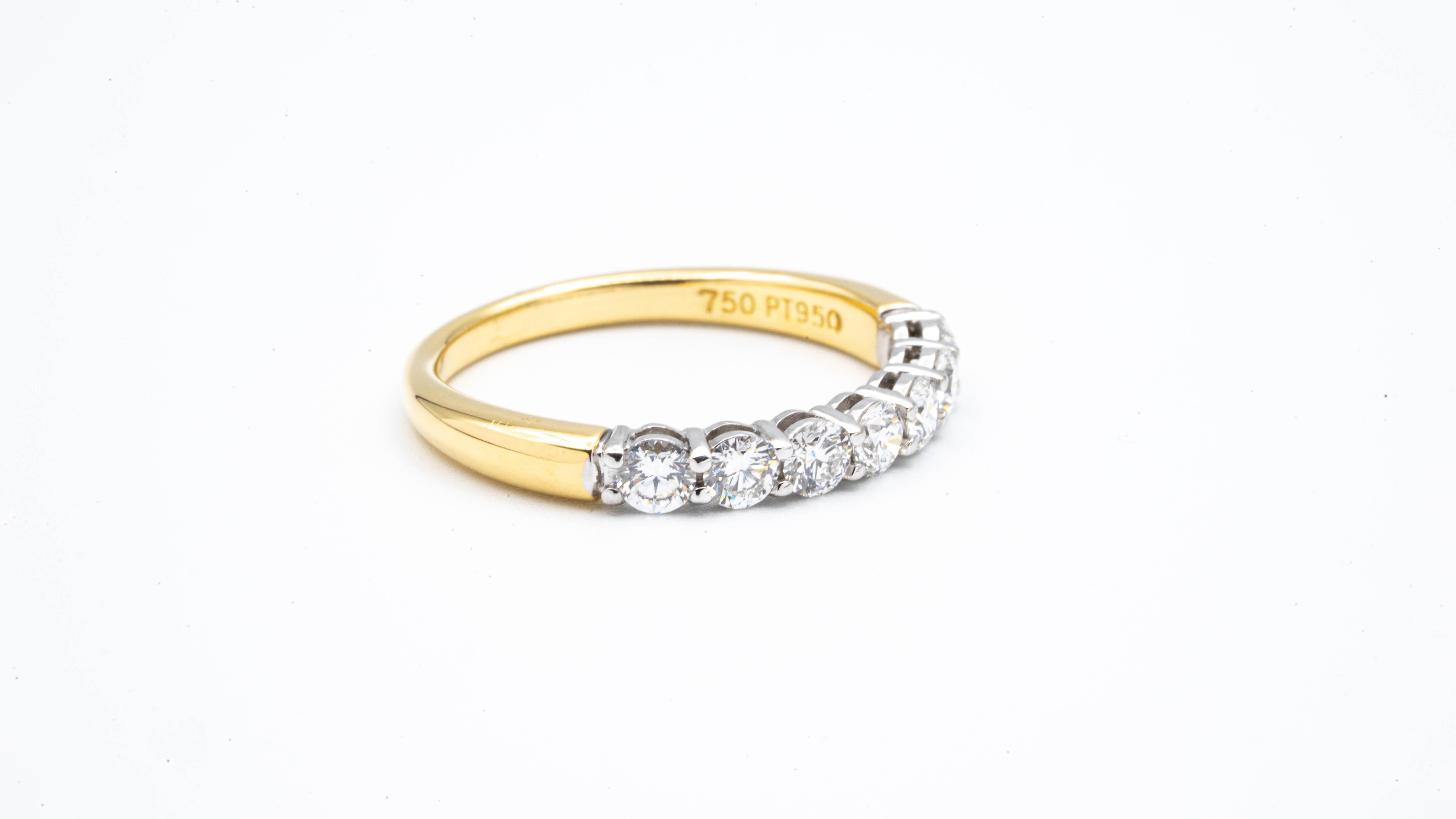 Tiffany & Co. Band ring finely crafted in platinum and 18 Karat yellow gold with 7 Round Brilliant cut diamonds weighing .57 carats total weight approximately. 

Stamp: Tiffany & Co. PT950
Size: 6.25 ( can re-size)
Includes Tiffany Black Suede Box