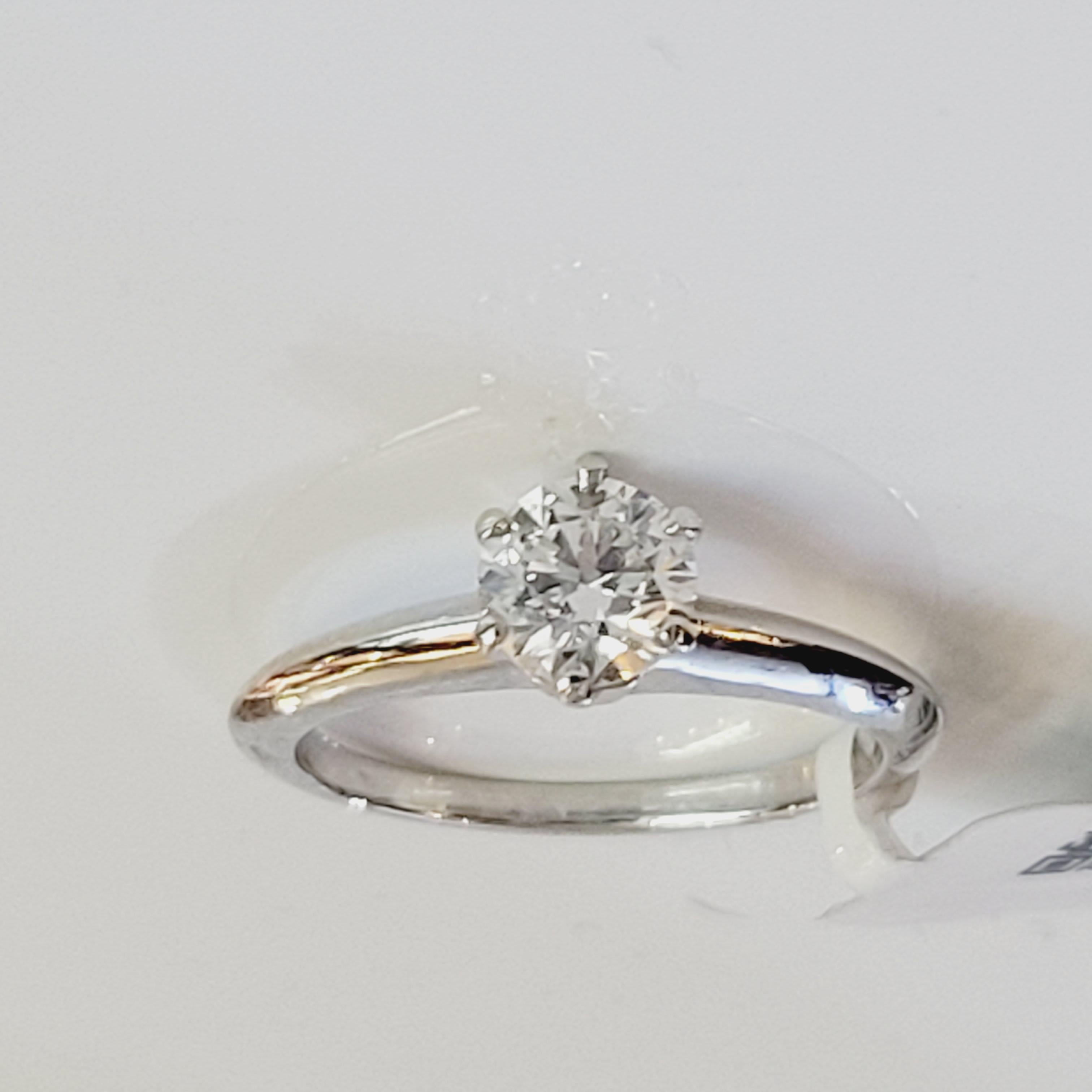  Tiffany & Co. .72 ct Diamond Engagement Ring Plat H VS1 Box & Papers

Tiffany & Co. solitaire engagement ring with a 0.72 ct single round brilliant cut diamond center stone. This Tiffany ring has the serial number of the diamond engraved inside the