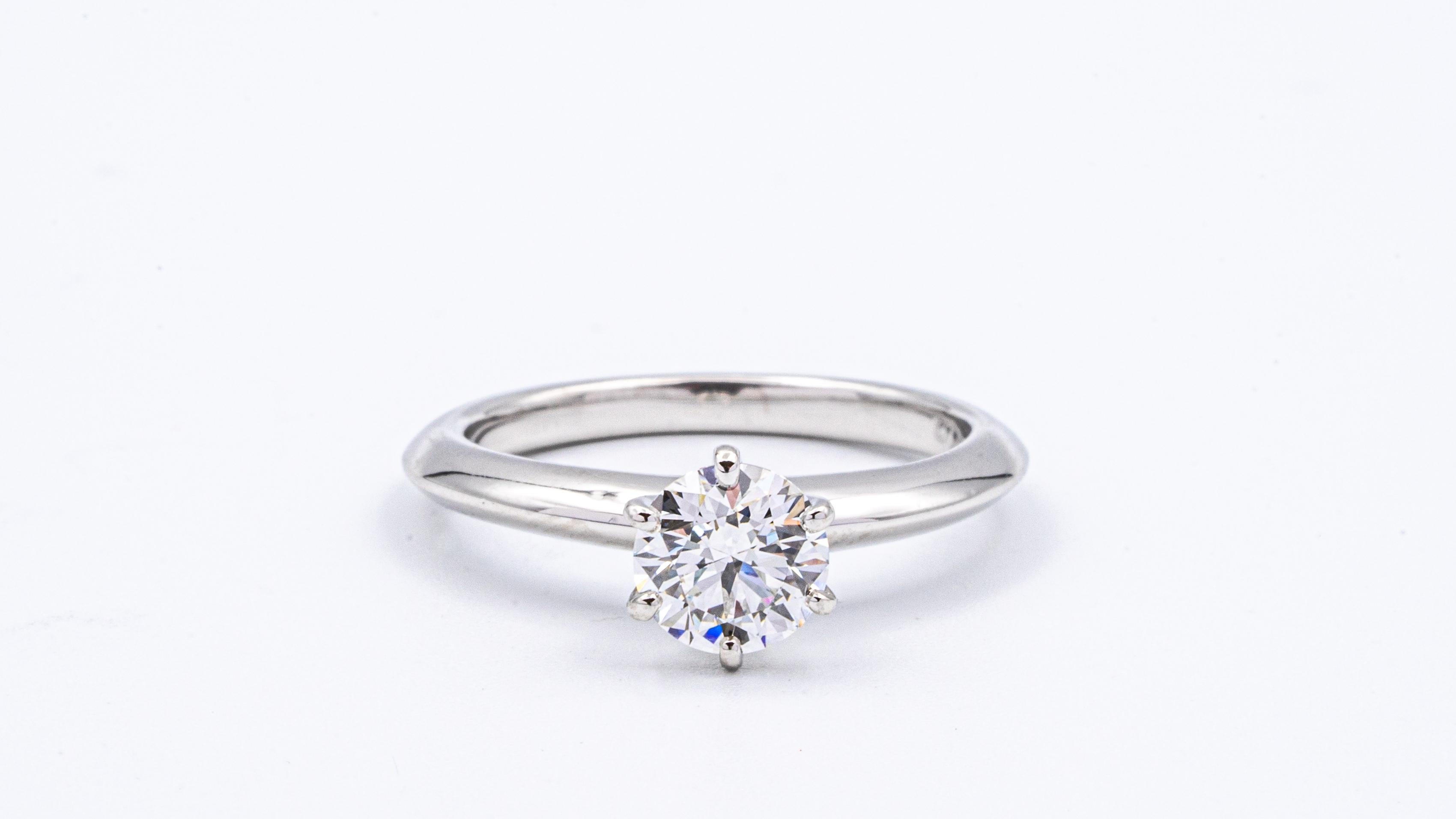 Classic Tiffany & Co Round Brilliant Solitaire Engagement Ring featuring a 0.77 ct Excellent Cut Center G color, VS1 clarity, finely crafted in a 6 prong Platinum Mounting. 
Includes Original Tiffany certificate and Box. 

Stamped: Tiffany & Co. PT