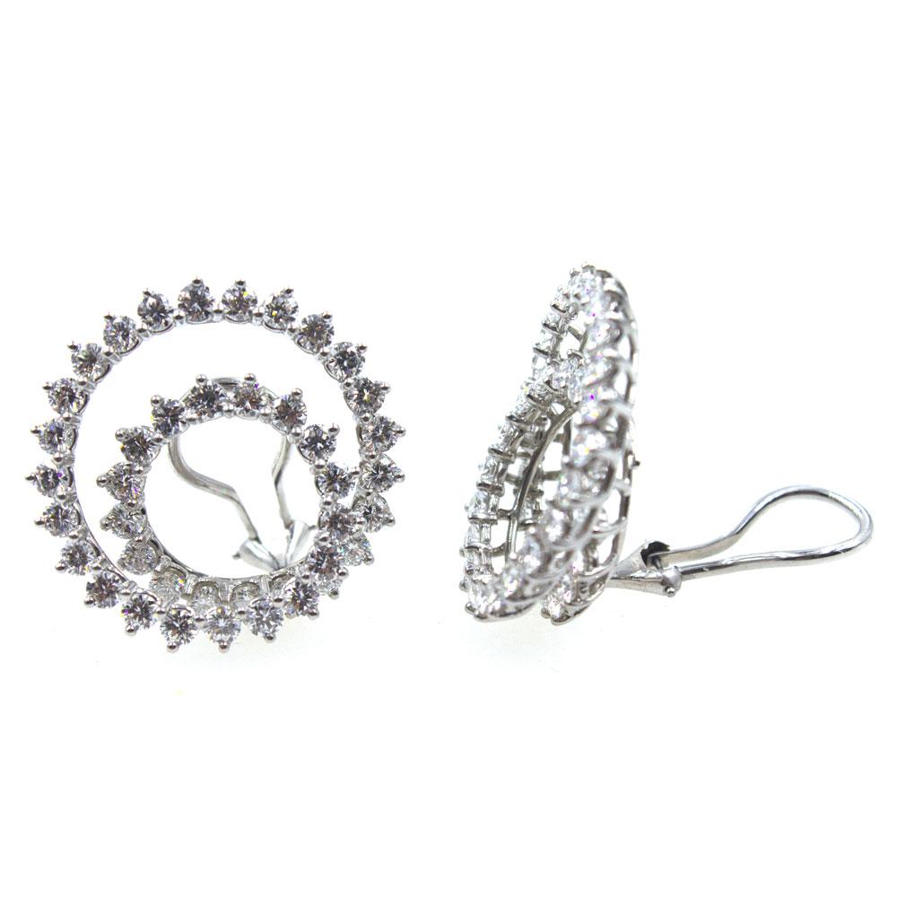 Beautiful and classy diamond swirl earrings by Tiffany & Co.  Timeless and crafted in platinum, the large swirls feature 82 round brilliant cut diamonds that equal 8.00 carat total weight. The diamonds are graded F-G color and VS clarity. The