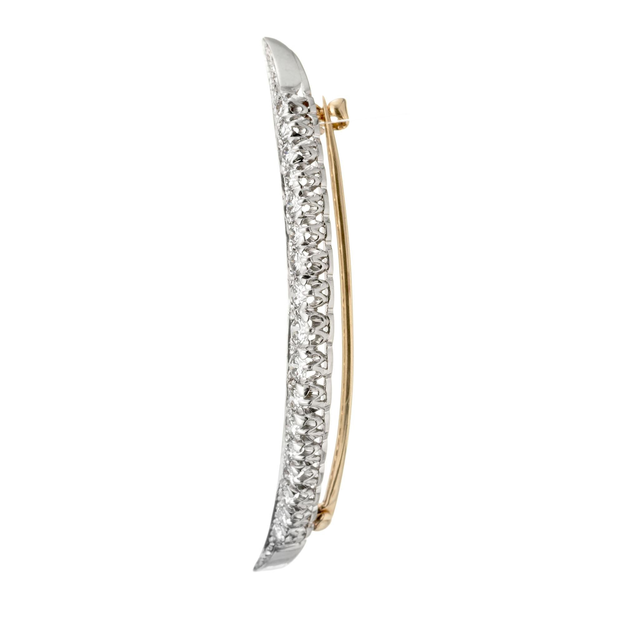 Tiffany & Co crescent moon platinum and 18k yellow gold 17 round brilliant cut diamond brooch. Circa 1957

17 round brilliant cut diamonds, G-H VS approx. .80cts
Platinum 
Stamped: 10% IRID PLAT
Hallmark: Tiffany & Co
5.0 grams
Top to bottom: 50.3mm
