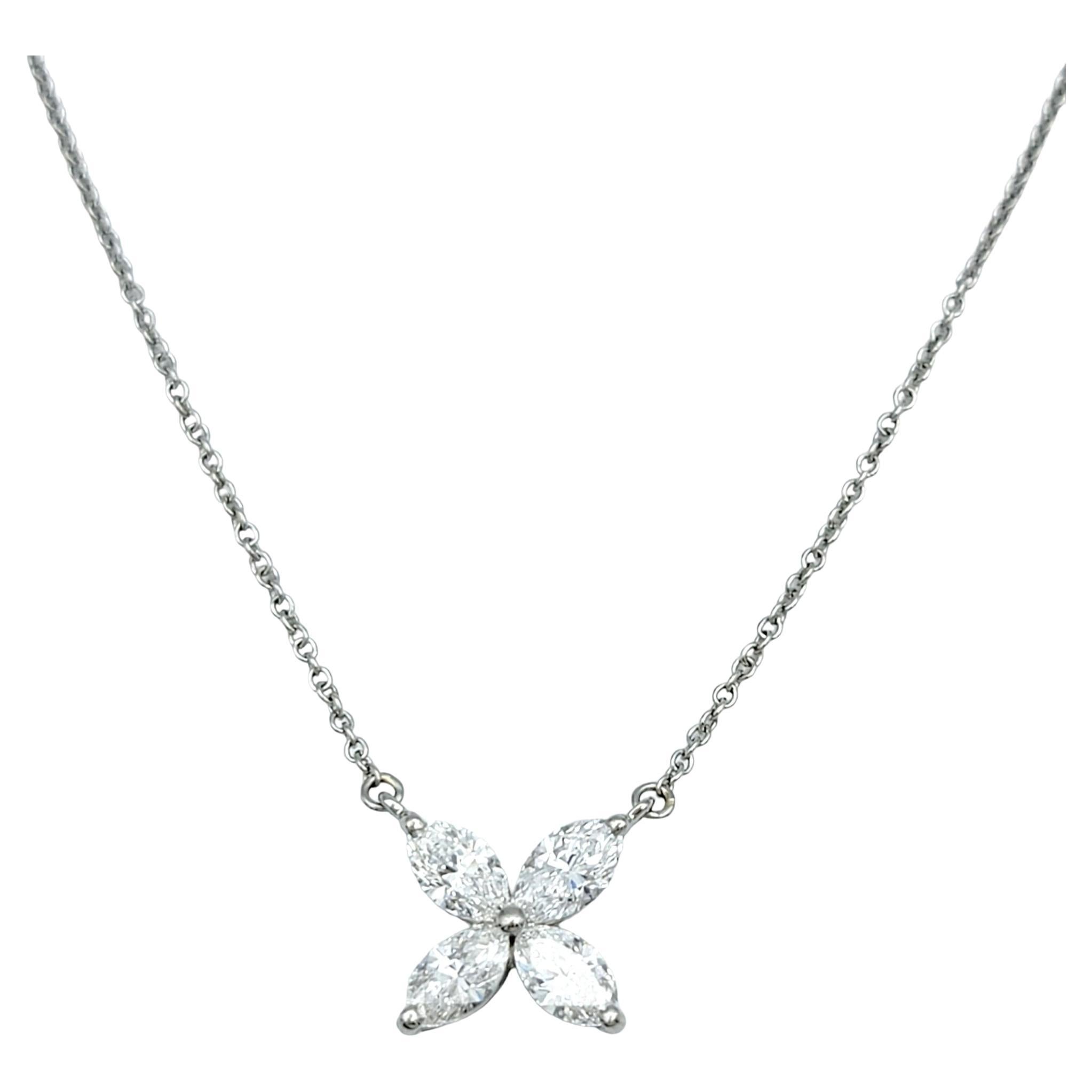 Introducing the epitome of elegance: The Tiffany & Co. Victoria Pendant Necklace in platinum. This exquisite piece features four captivating marquise-shaped diamonds, meticulously set to radiate timeless beauty. Totaling a breathtaking 0.81 carats,