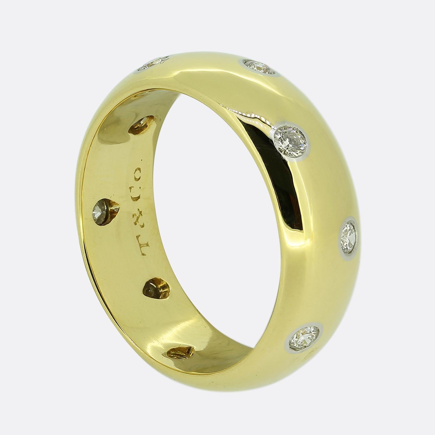 Here we have a wide 18ct yellow gold band ring from the world renowned jewellery designer, Tiffany & Co. This piece forms part of the 'Etoile' collection and showcases 12 round brilliant cut diamonds individually rub-over set in platinum in a