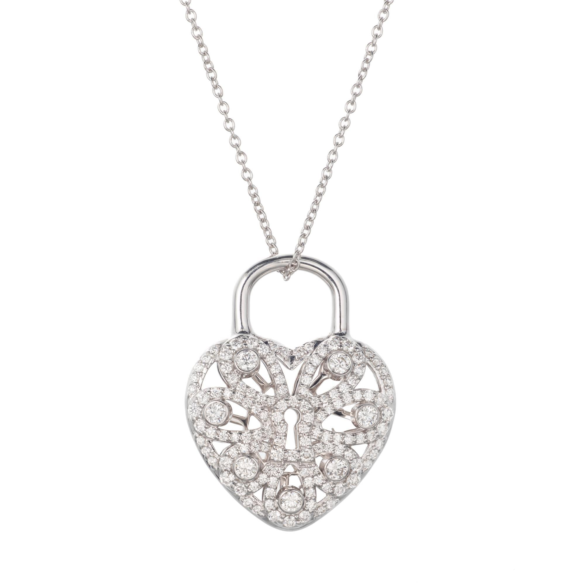 3-D heart pendant with diamond pave front and open work back that spells out TIFFANY.  18 inch white gold chain.

120 full cut round G-H VS diamonds, Approximate .90cts 
18k white gold 
Chain: 18 inches
Stamped: Au 750
Hallmark: Tiffany & co
8.0