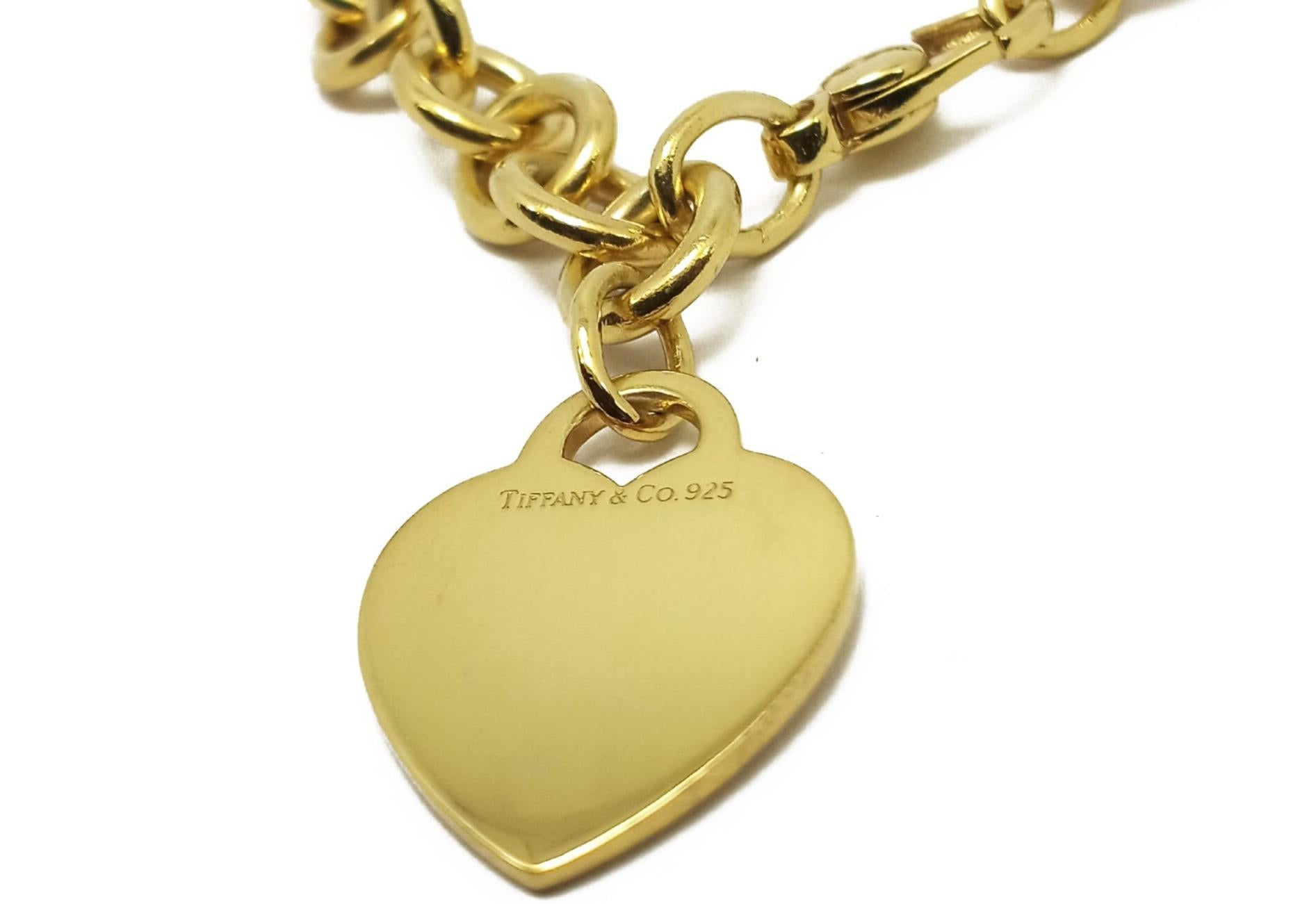 (Item Description)
Brand - Tiffany &Co.
Gender - Unisex
Condition - Pre-Owned 
Style - Heart Charm Bracelet  
Metals - .925 Silver
Weight - 34 Grams
Coating - 24K Yellow Gold
Hall marks - Tiffany &Co. 925
length - 7 1/2 inches
(Tiffany Box & Pouch