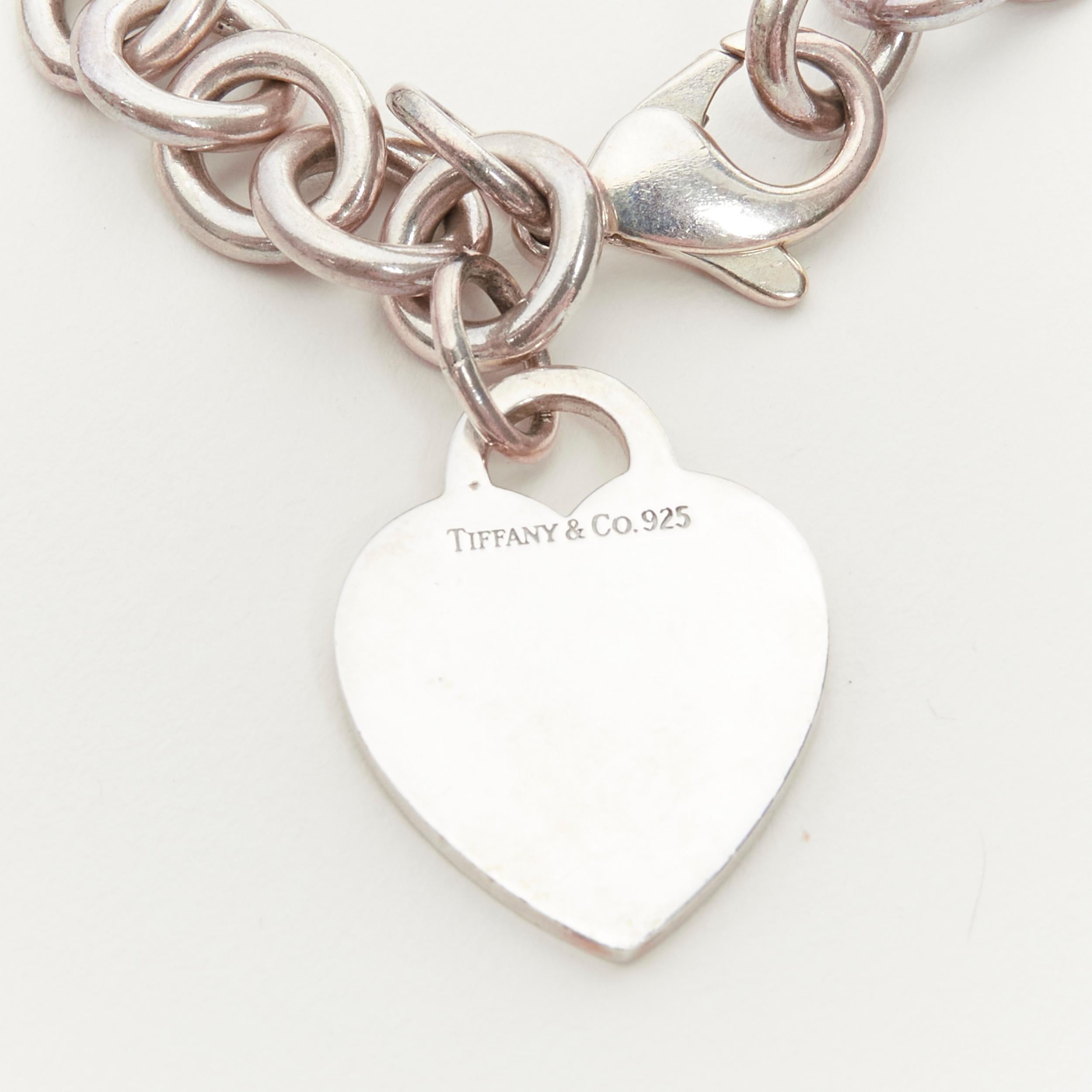 TIFFANY & CO. 925 Silver Heart Tag Charm chain linked bracelet 
Reference: ANWU/A00109 
Brand: Tiffany & Co. 
Material: Silver 
Color: Silver 
Pattern: Solid 
Closure: Lobster 

CONDITION: 
Condition: Good, this item was pre-owned and is in good