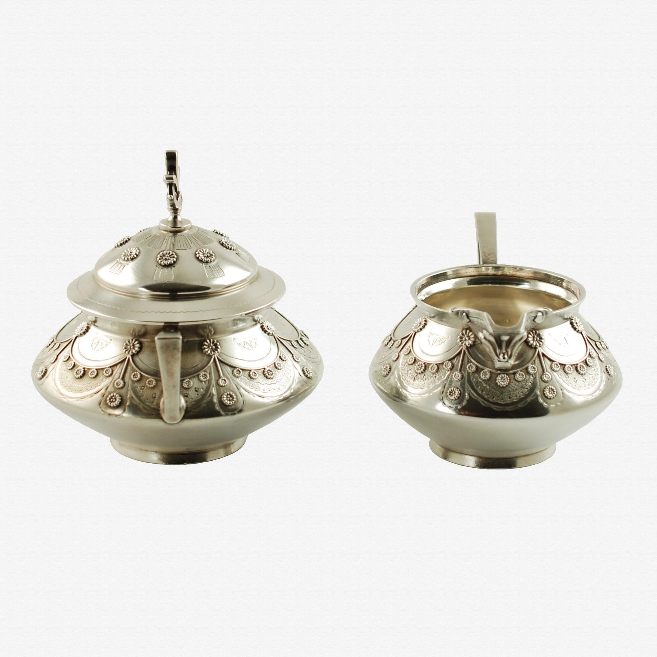 Antique Tiffany & Co Aesthetic Movement sterling silver cream and sugar. This striking 19th century matched cream and sugar set was made by renowned jeweler and silversmith, Tiffany & Company. Tiffany was founded in 1837 by Charles Lewis Tiffany and