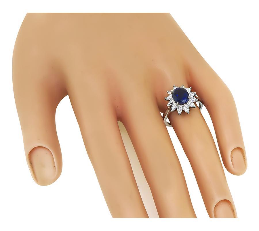 This is a stunning platinum engagement ring by Tiffany & Co. The ring is centered with a lovely GAL certified oval cut sapphire that weighs approximately 3.00ct. The sapphire is accentuated by sparkling pear shape diamonds that weigh approximately