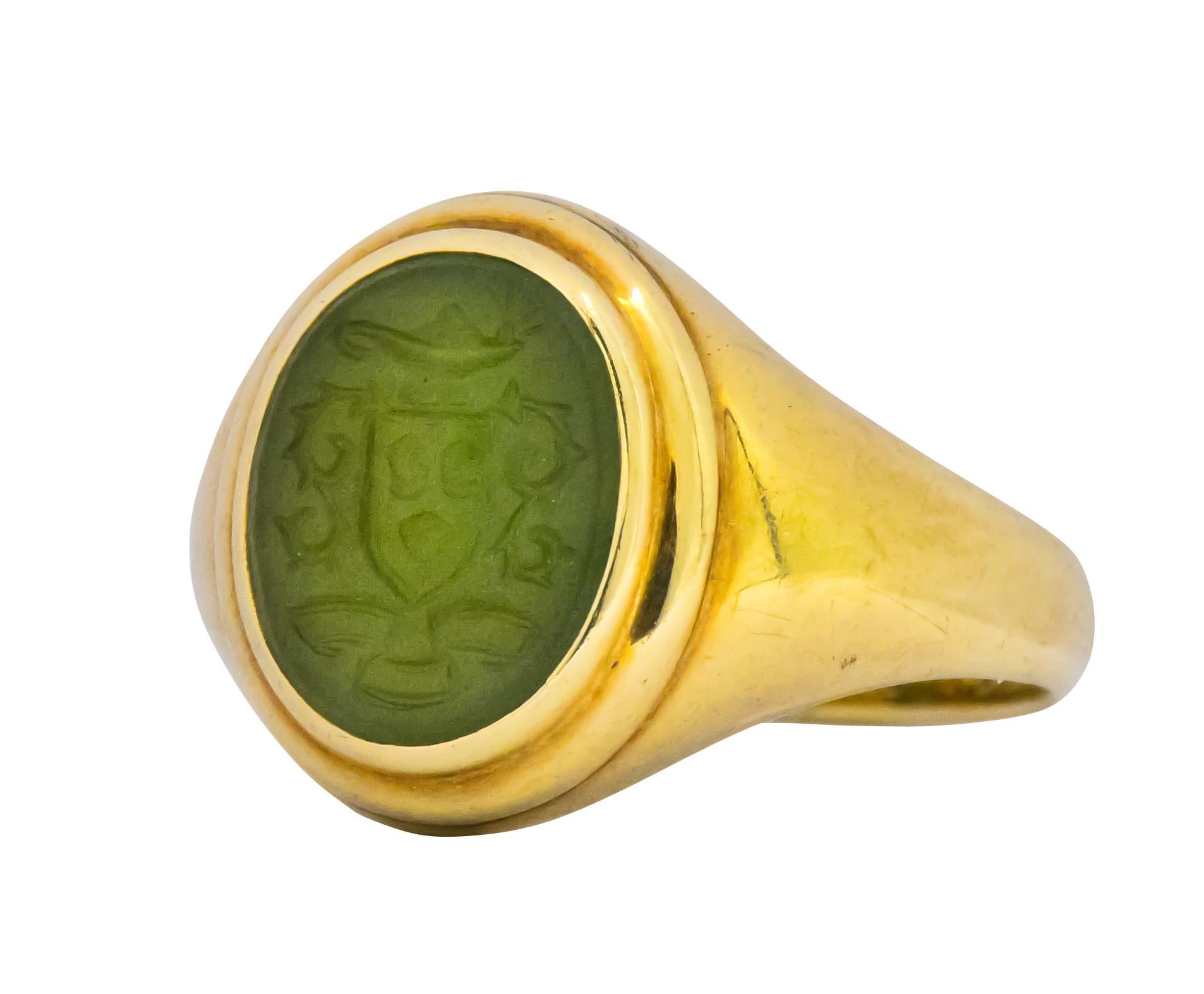 Very fun and unique vintage Tiffany & Co. Aladdin carved jade intaglio seal ring. The jade depicts a magic lamp, a shield, swirls and three circular objects. The beautifully carved oval jade is bezel set in 14K yellow gold. The inside of the ring is
