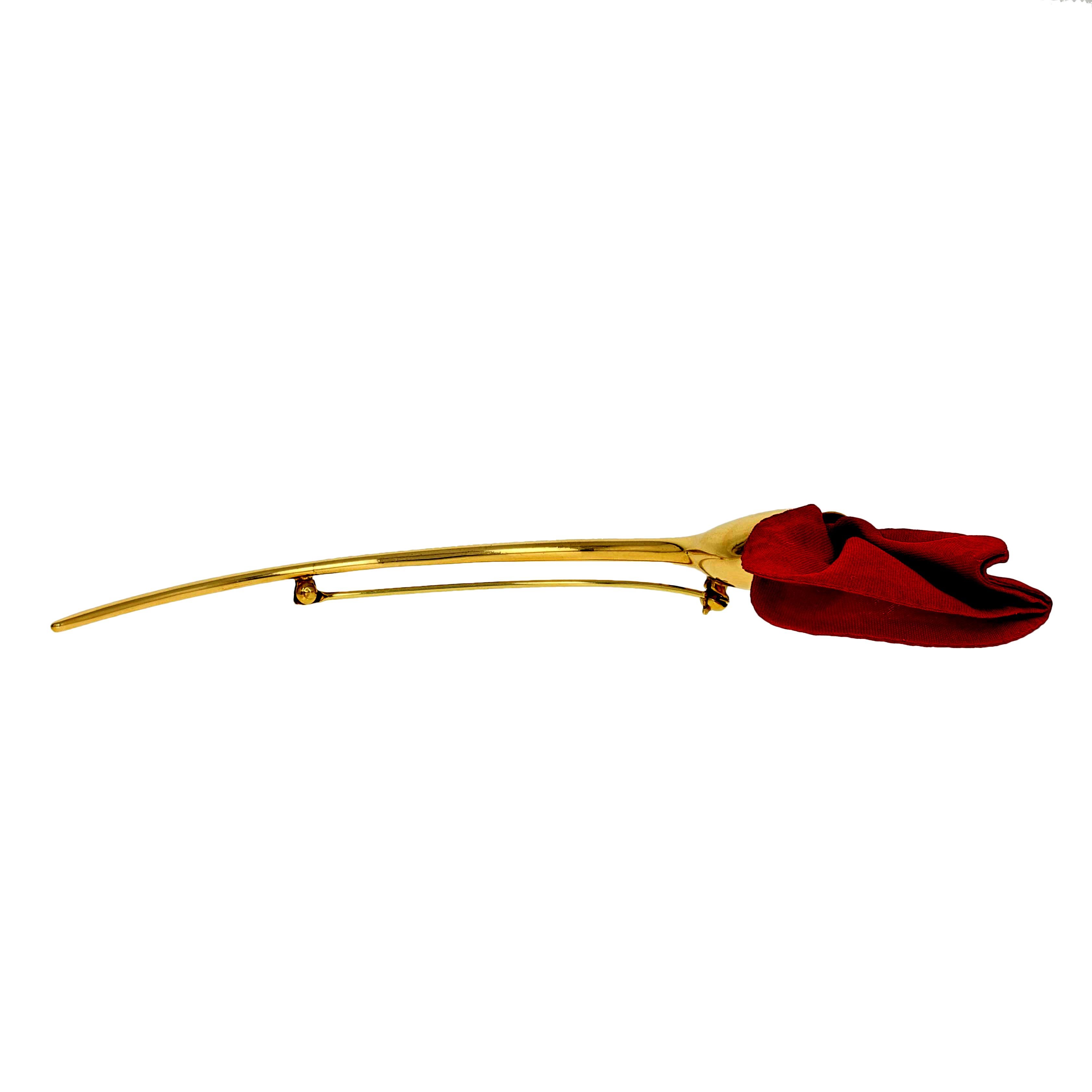 This Tiffany & Co. brooch is destined to become a signature piece in your jewelry collection! Beautifully designed by Elsa Peretti, this iconic Amapola pin is crafted in high purity 18k yellow gold highlighted by a vibrant red silk poppy blossom.