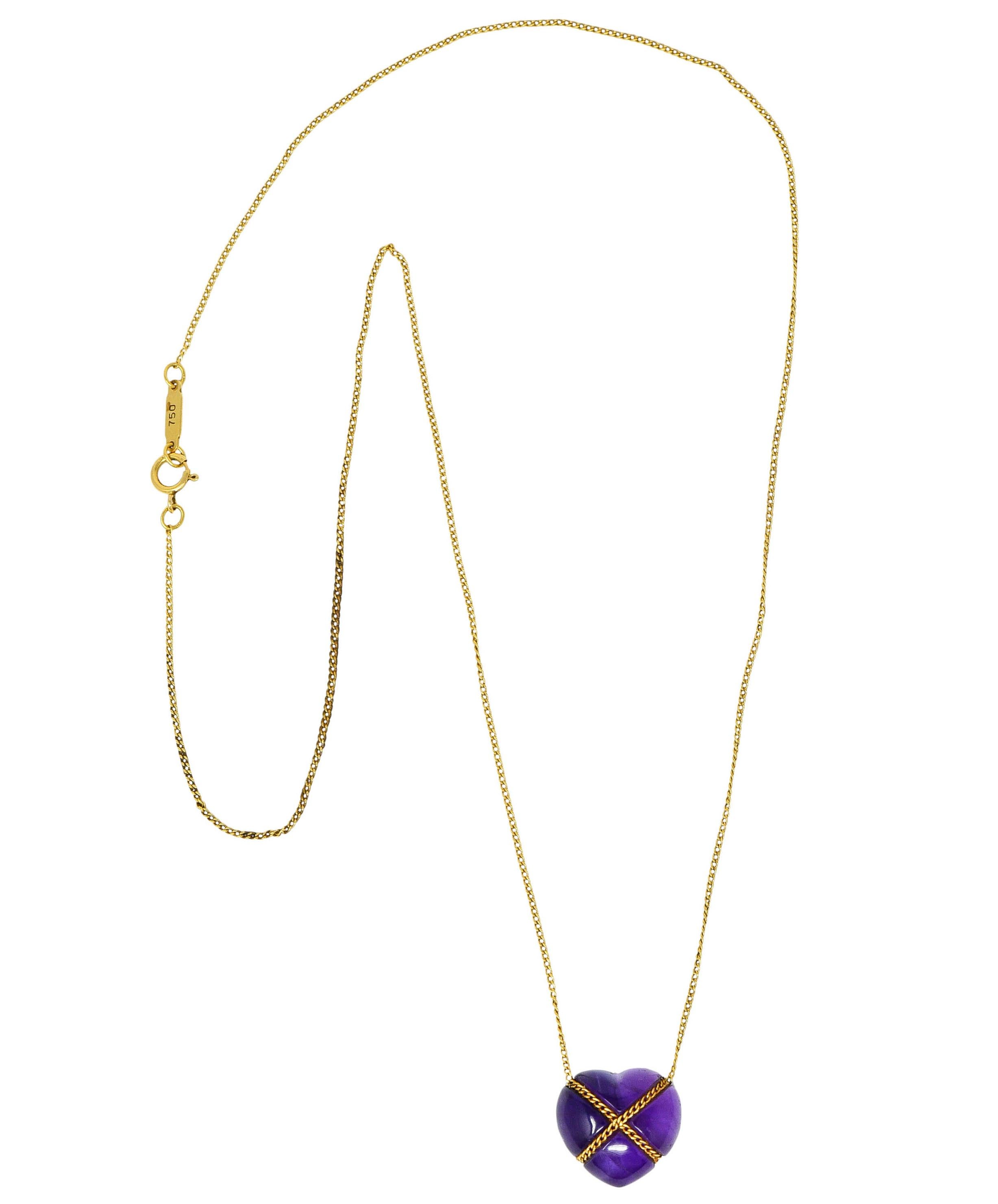 Classic curb chain necklace centers an amethyst heart cabochon

Bright purple and translucent with natural inclusions

Tightly wrapped with curb chain in an X motif

Necklace completes as a spring ring clasp

Logo link is stamped 750 for 18 karat