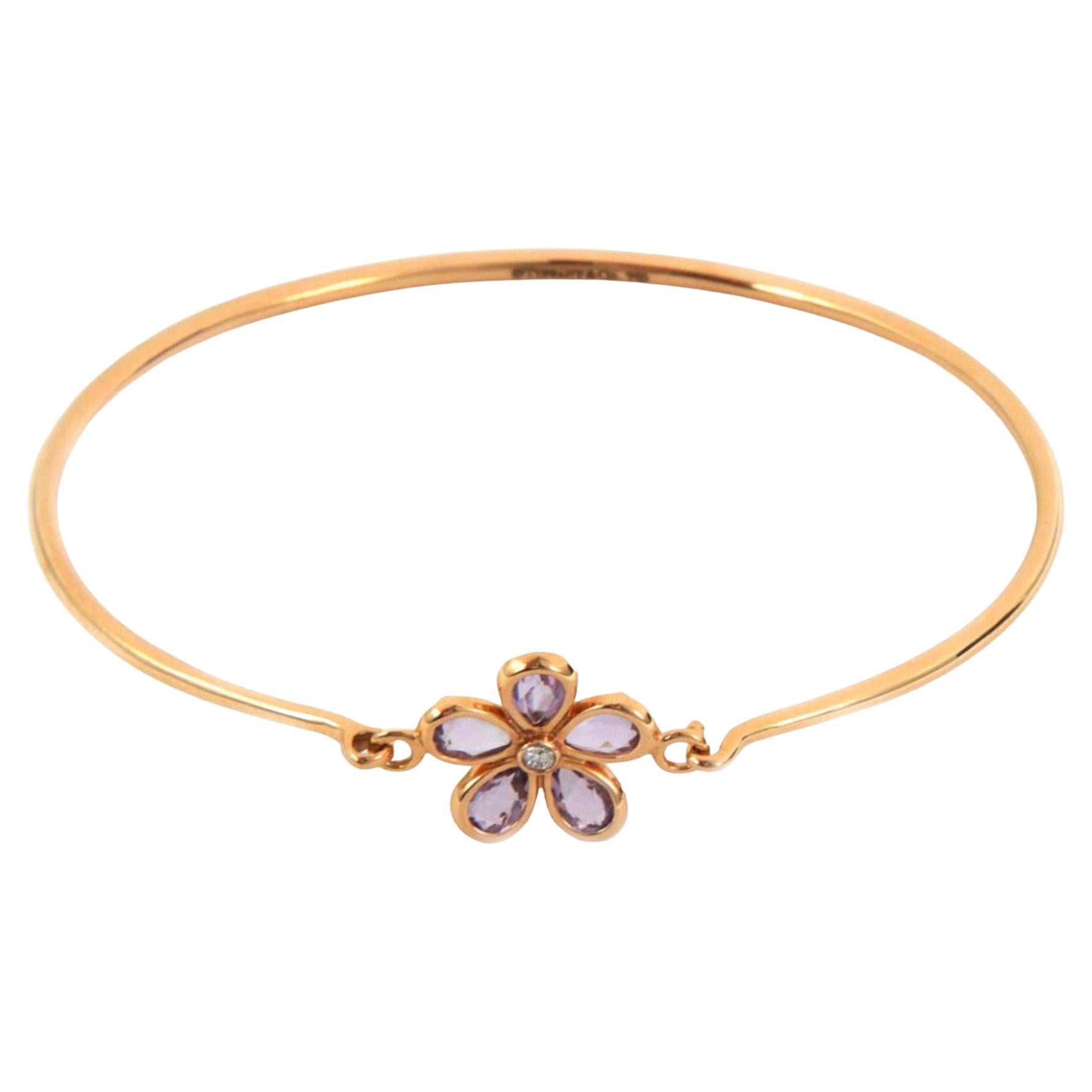 Beautiful and authentic by Tiffany & Co. from their Garden Collection, this adorable purple flower has 5 pear shape amethyst gemstones in pear shape 18k rose gold floral frame with a 2 points diamond in the center. The 18k rose gold wire bangle has