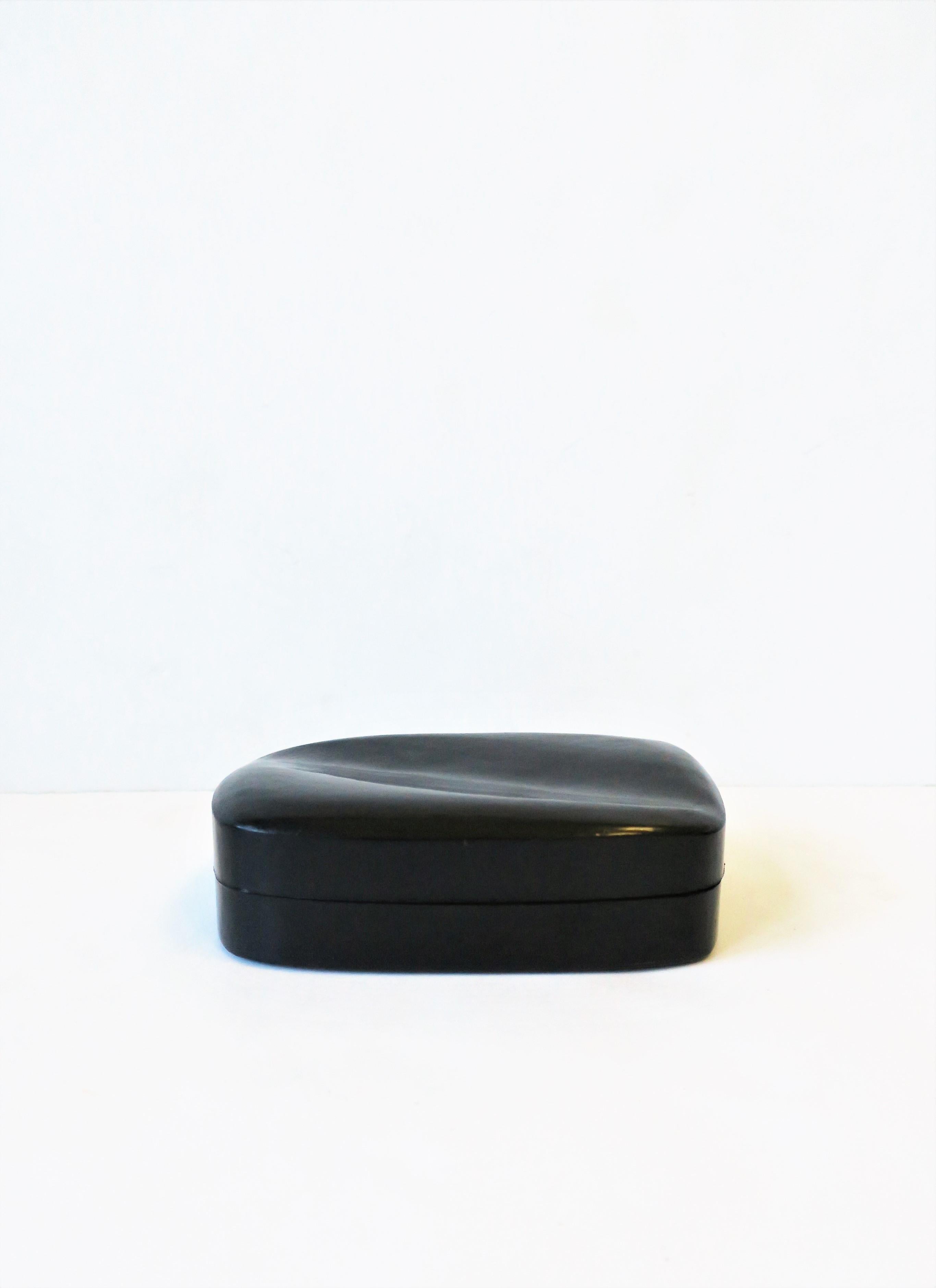 A beautiful dark blue and tan suede leather jewelry box from luxury maker Tiffany & Co. and designer Elsa Peretti. Box has the iconic Elsa Peretti organic modern form top. Box is made in Italy (marked on bottom.) With marker's and designer marks on