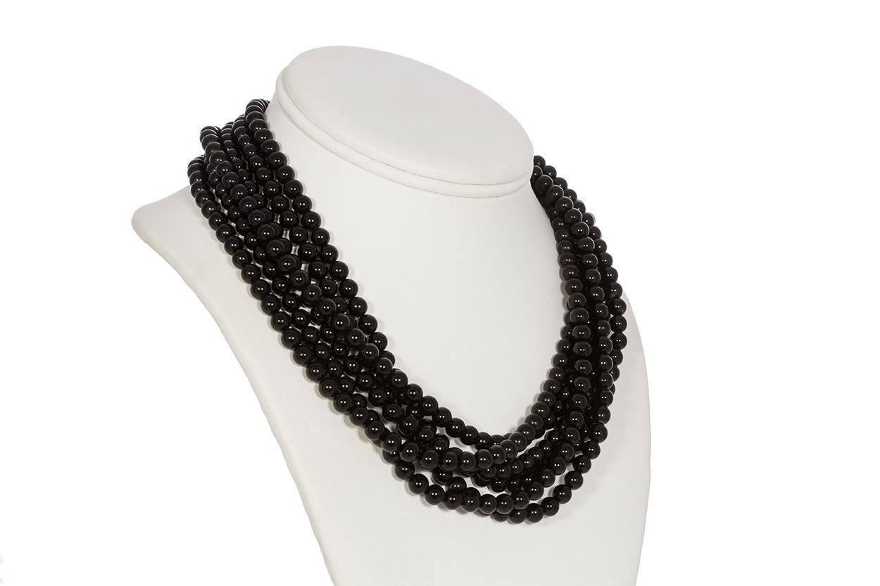 We are pleased to offer this Tiffany & Co. Angela Cummings 18k Gold & Onyx Bead Necklace. This piece features multiple strands of black onyx beads with an 18k yellow gold clasp all done in Angela Cummings classic styling. It measures 17.25 inches in
