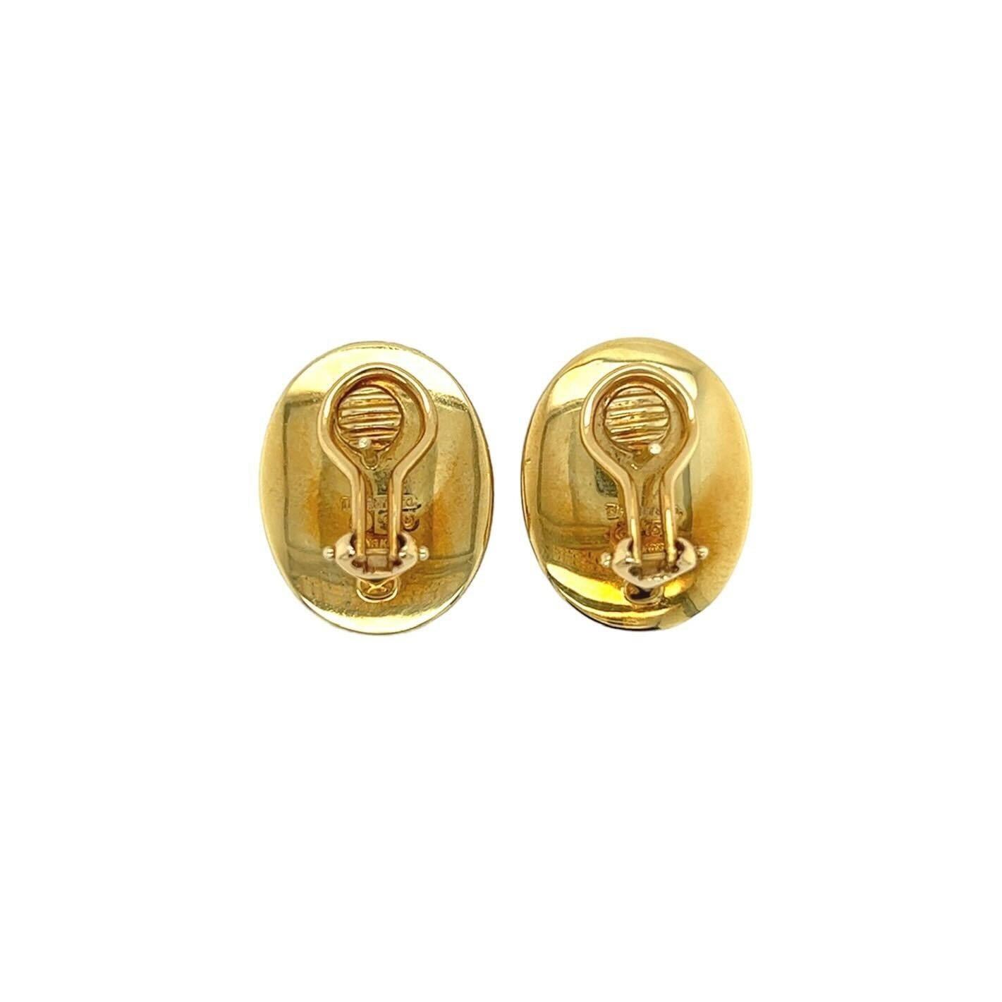 A pair of 18 karat yellow gold and mother of pearl earrings, Tiffany & Co.designed by Angela Cummings, circa 1980s. The “Positive and Negative” model  designed as domed ovals of polished yellow gold and white mother of pearl inlay. Length