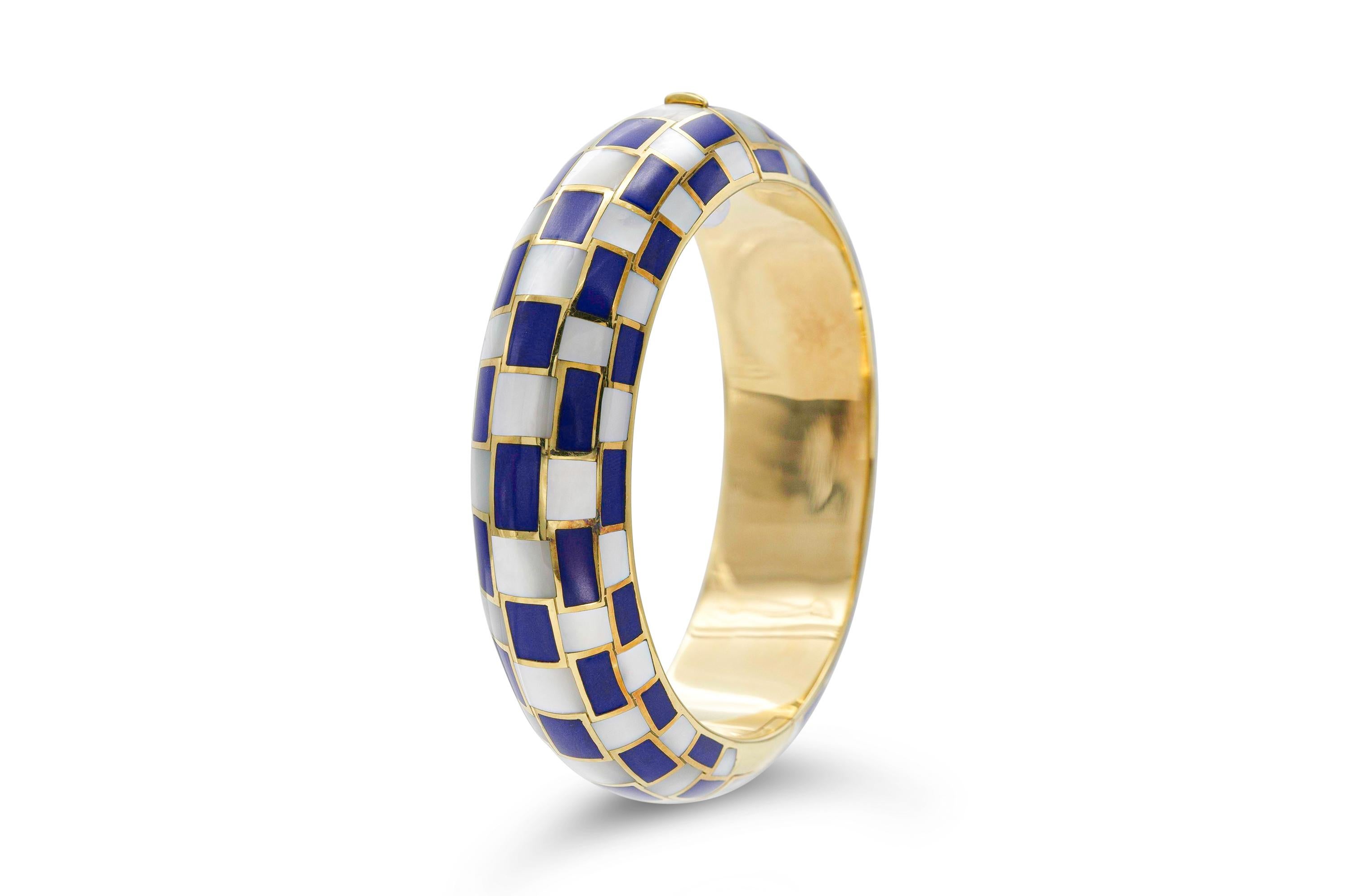 Finely crafted in 18k yellow gold with Lapis and Mother of Pearl.
Signed by Tiffany & Co. and Angela Cummings
Size 6 1/2 inches