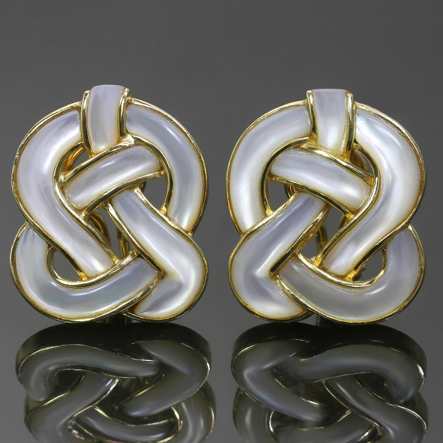 These classic vintage Tiffany & Co. clip-on earrings were designed by Angela Cummings and feature an elegant knotted design crafted in 18k yellow gold and inlaid with Mother-of-Pearl. Show normal signs of wear including light scratches and minor