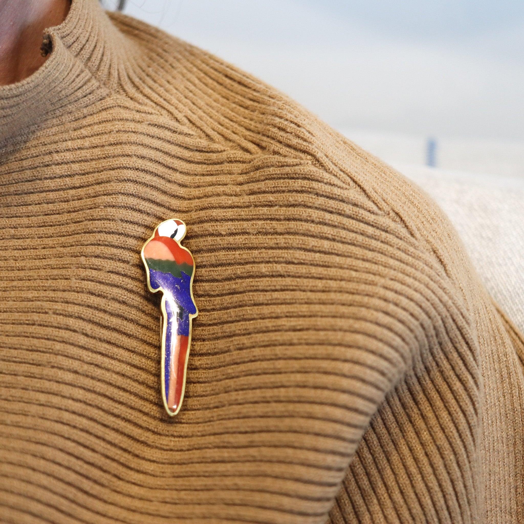 Parrot brooch designed by Angela Cummings for Tiffany & Co.

This is a very rare colorful parrot brooch, created in New York City by Angela Cummings for Tiffany & Co., back in the 1980. The statement brooch has been crafted in the shape of a
