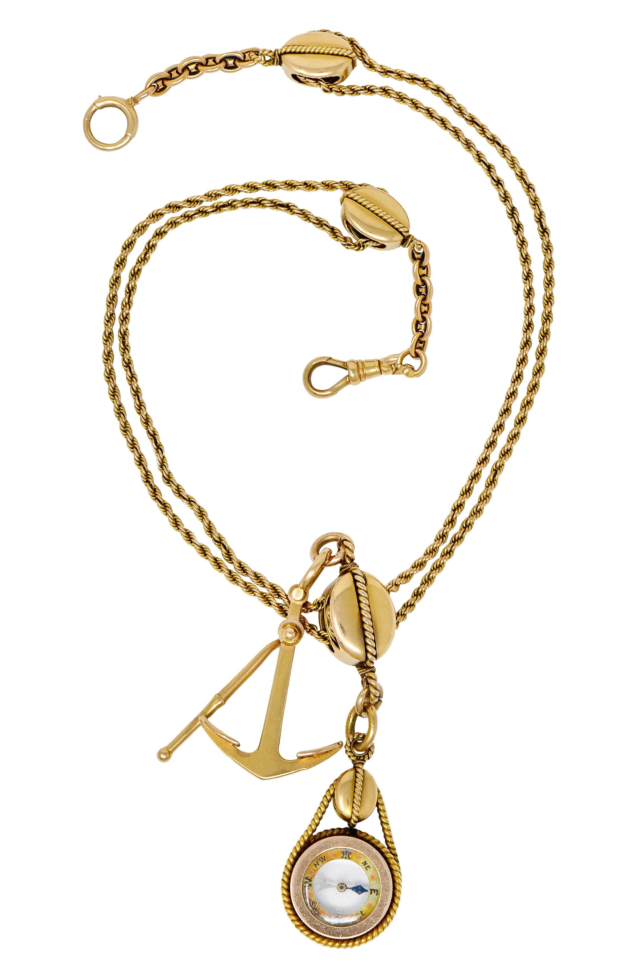 Designed with double strands of twisted rope chain threading through three functional pulley stations

Suspending a glass antique compass and a stylized polished gold anchor with a swinging pendulum; each charm is counterbalanced at each end of