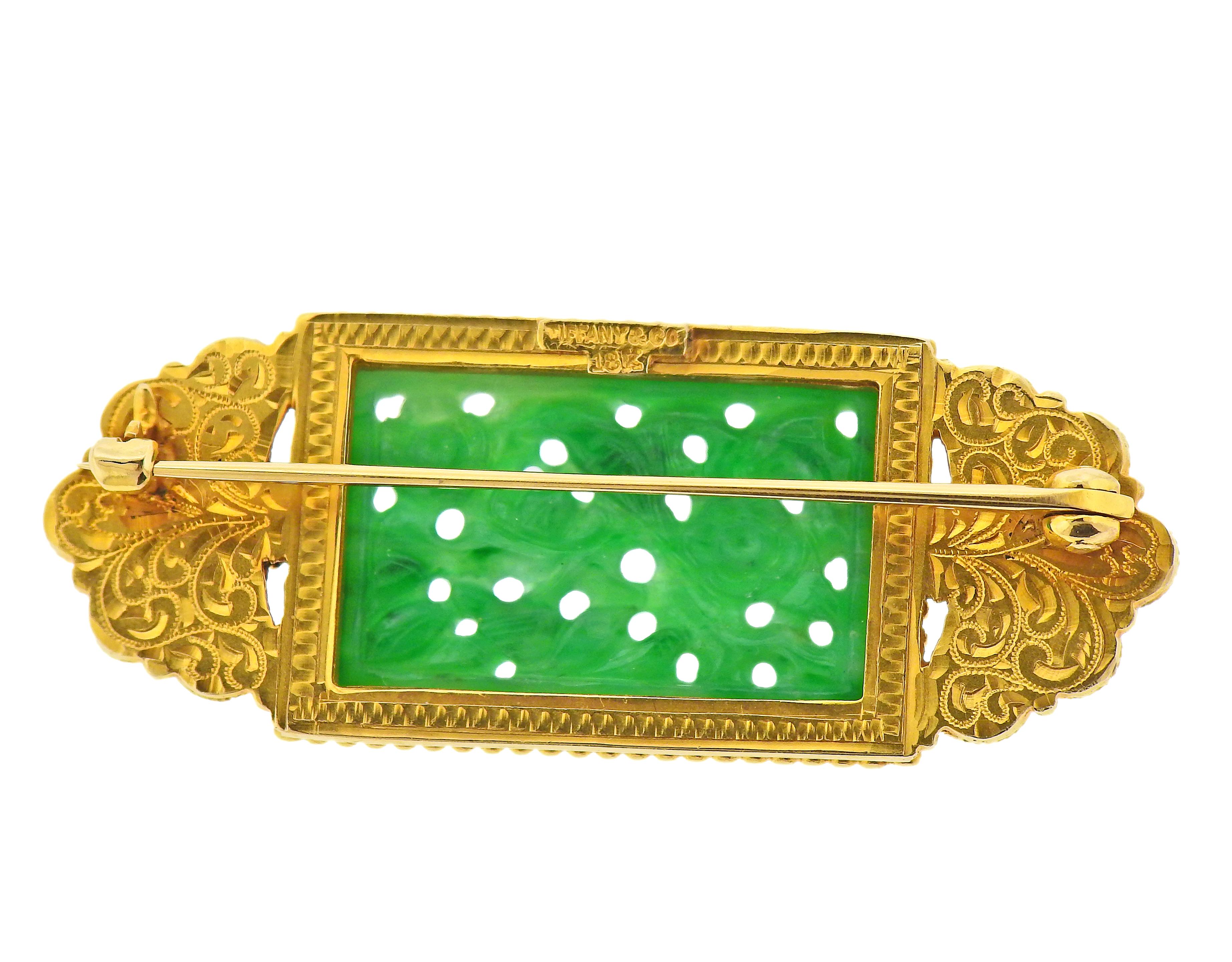 Antique Tiffany & Co 18k gold brooch with carved jade. Brooch measures 52mm x 20mm. Center jade - 16mm x 25mm. Marked: Tiffany & Co 18k. Weight - 14.2 grams. 