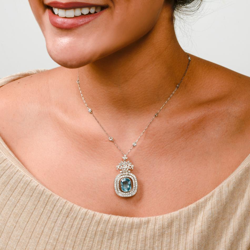 This enchanting Tiffany & Co. antique 1920's pendant is crafted in solid platinum. Pendant displays 108 bezel set round European cut diamond, approx. 3.10 carats, G-H color, VS clarity floral vase motif featuring three moving parts centered by an