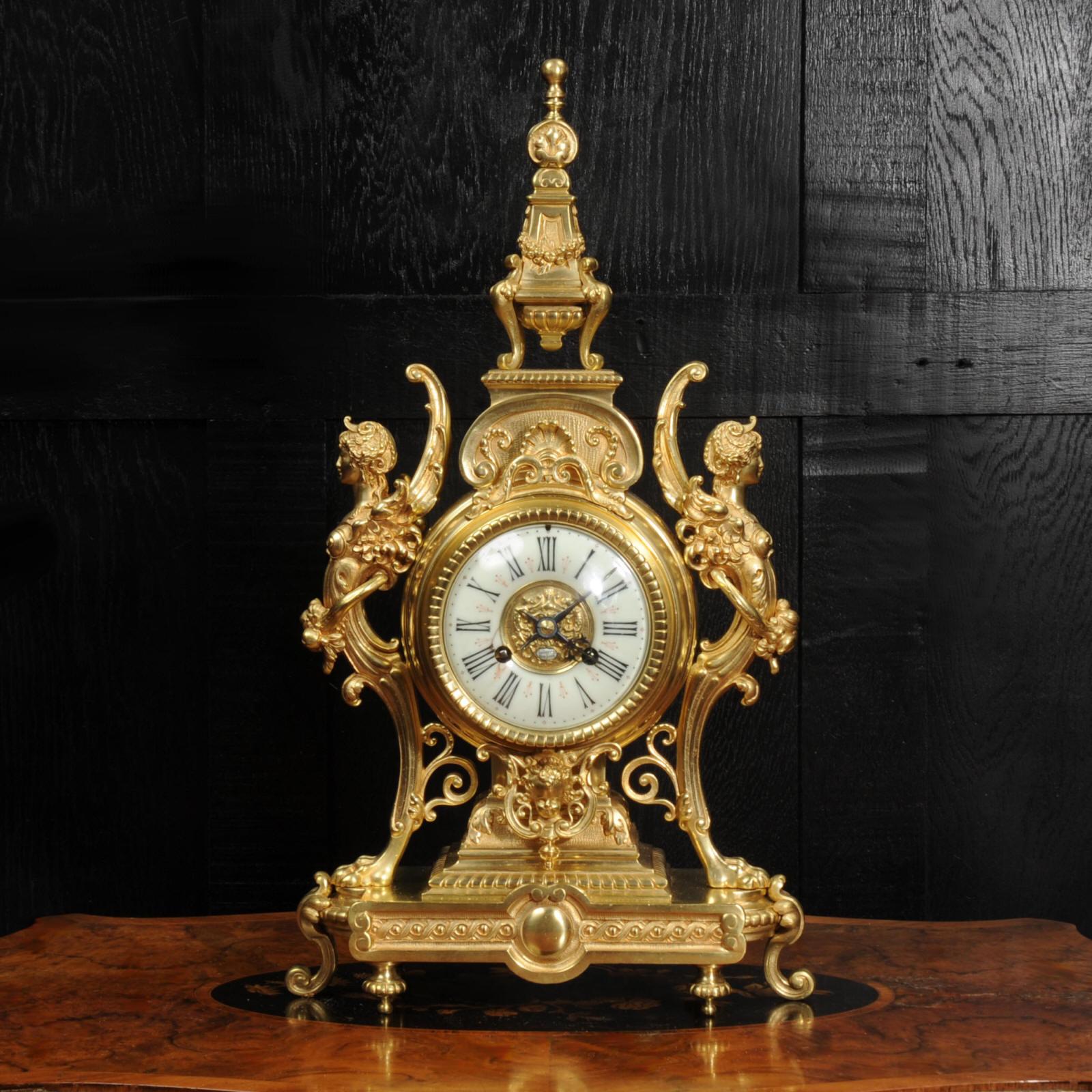 A large and superb gilt bronze antique French clock, retailed by Tiffany & Co, New York. Beautifully modelled in the Baroque style most likely by the famous Bronze founder Maison Baguès. The clock is mounted in a drum supported by winged goddesses