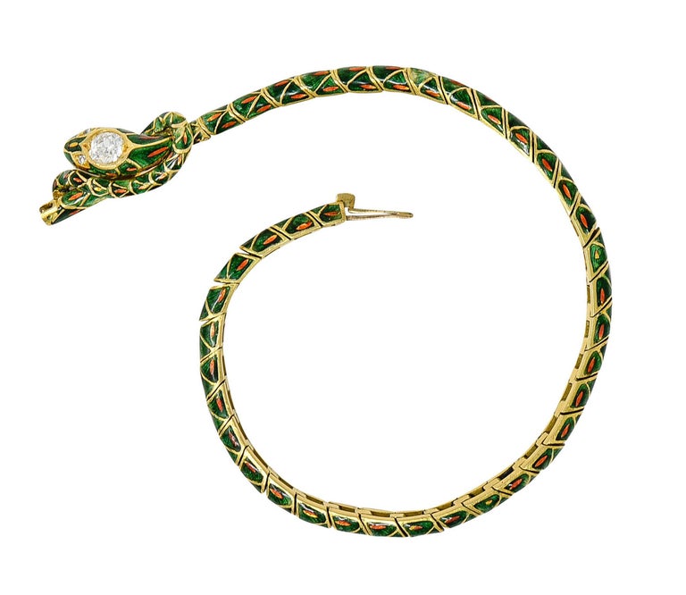 Bracelet is designed as a snake coiling into a love knot motif

Comprised of articulated links in a stylish scalloped design and deeply ridged

Glossed in transparent green enamel with orange accents - some loss consistent with age

Head features an