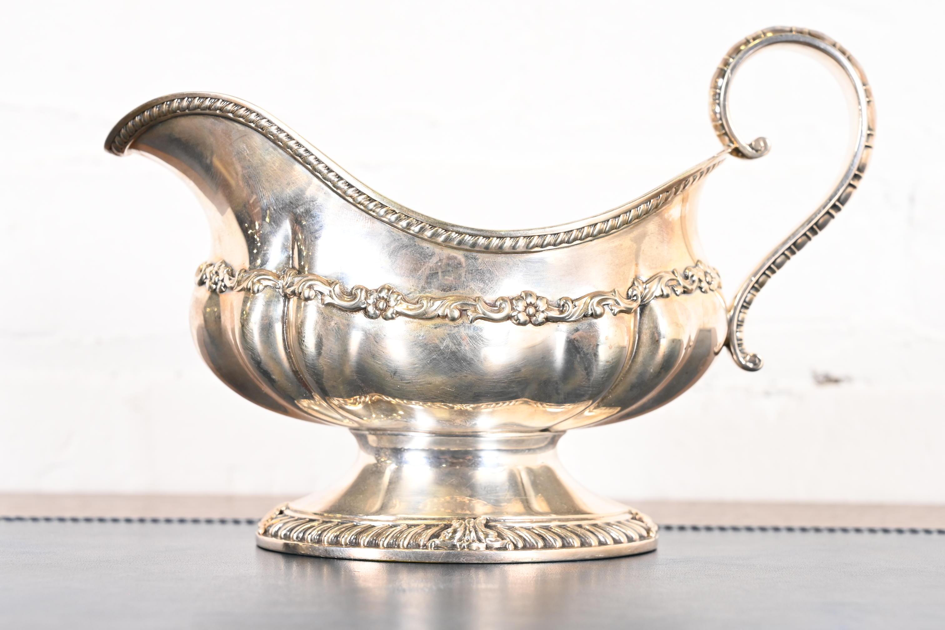 A gorgeous antique repoussé silver soldered gravy boat with floral design

By Tiffany & Co. (signed to the underside)

USA, Circa Late 19th Century

Measures: 7.75