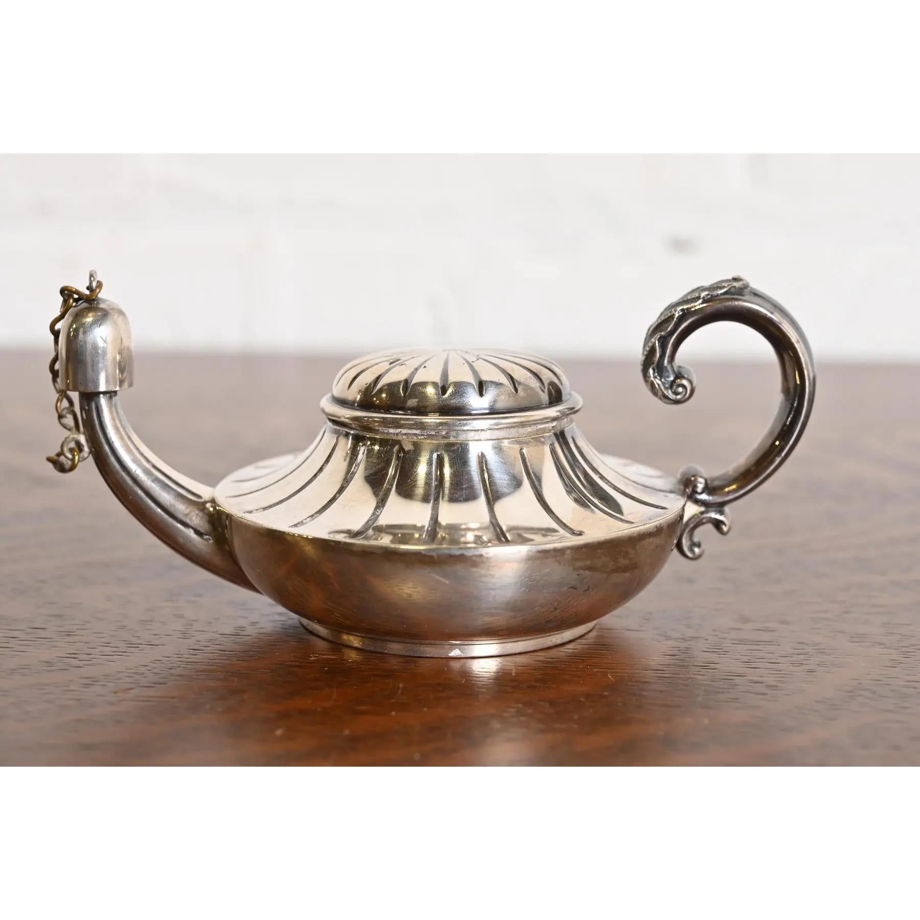 A gorgeous antique Victorian silver soldered Aladdin lamp form table cigar lighter

By Tiffany & Co. (signed to the underside)

USA, Late 19th Century

Measures: 5.5