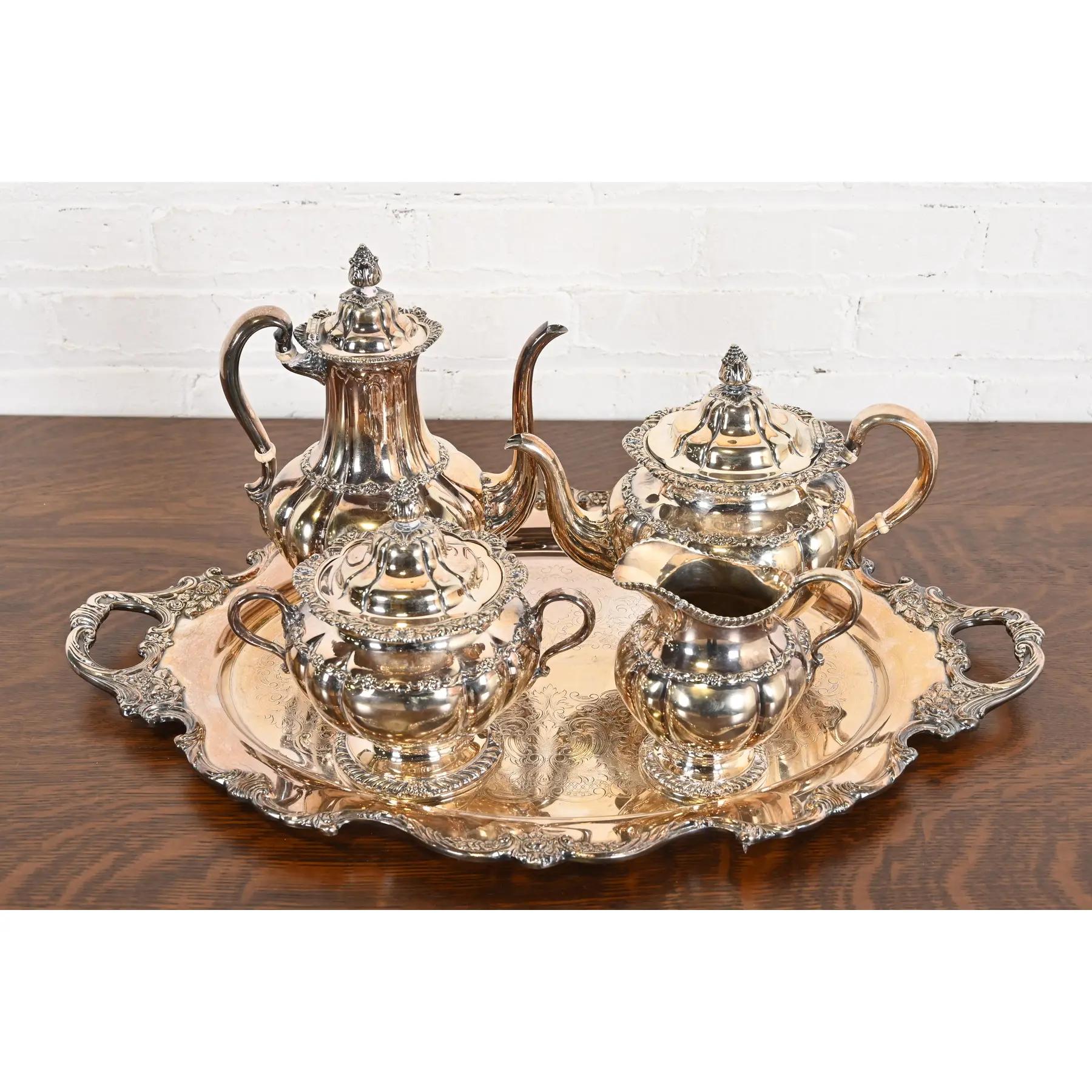 A gorgeous antique Victorian silverplate tea or coffee service set, including: tea pots, sugar, creamer, and large service tray.

By Tiffany & Co.

USA, Late 19th Century

Measurements:
5.5