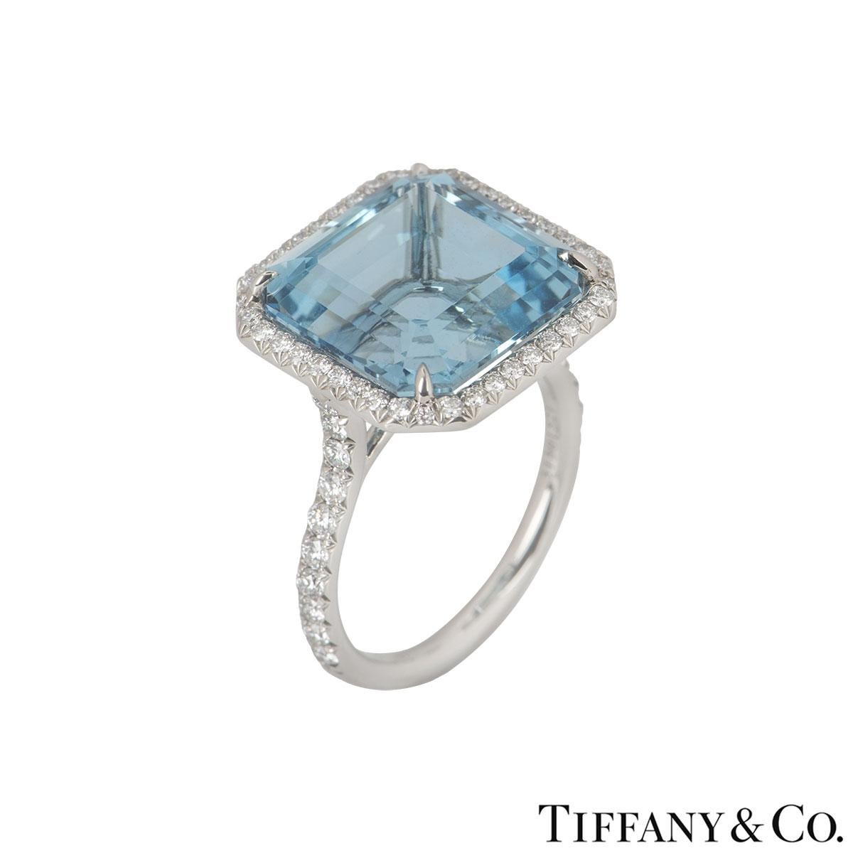 A beautiful platinum Tiffany & Co. aquamarine and diamond dress ring. The ring comprises of an ascher cut aquamarine in a 4 claw setting with a weight of approximately 8.34ct, with a light blue hue throughout. Complementing the gemstone is a halo of