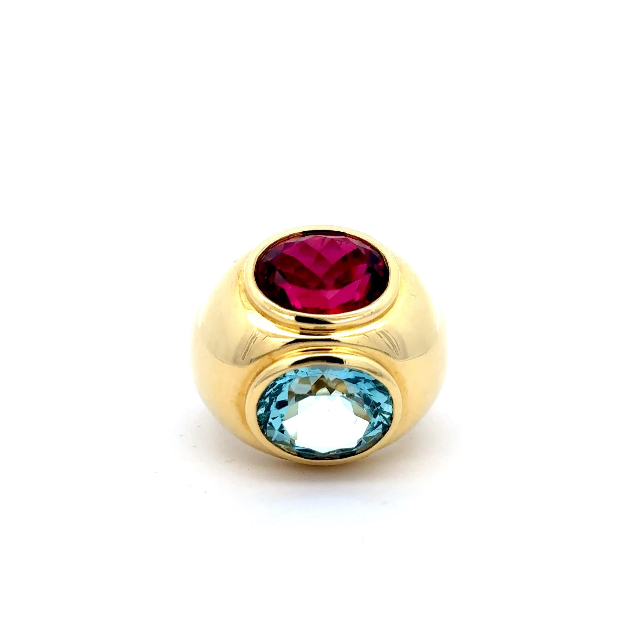 Estate Tiffany & Co, Aquamarine and Rubellite Ring in 18K Yellow Gold. The ring features a 5.65ct oval cut aquamarine and a 6.30ct oval cut rubellite. The ring is a size 5.5, weighs 24 grams, and is approximately 0.80