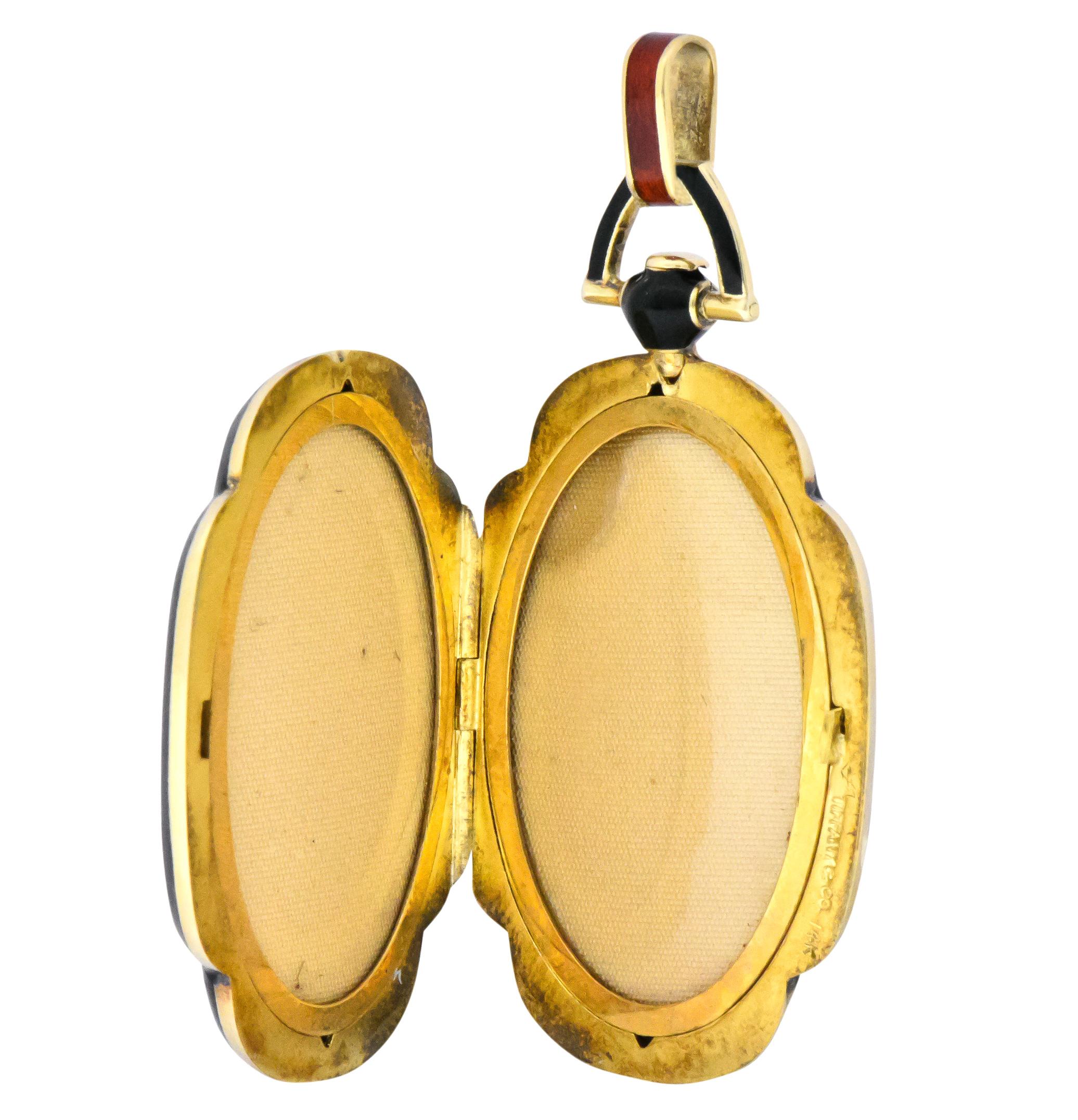 Featuring striking deep orange guilloché enamel, and bale

With a black enamel surround and bale

Opens to reveal an oval frame on each side

Fully signed Tiffany & Co. and stamped 14K

Measures: 2 (incl. bale) x 1 (widest) Inch

Total Weight: 17.2