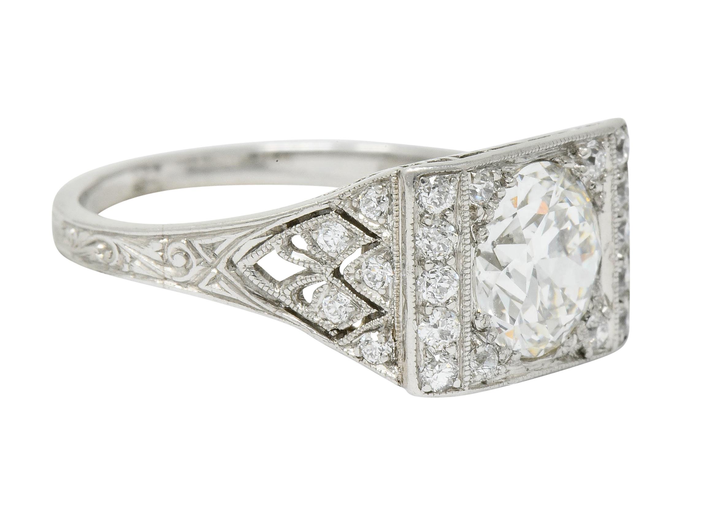 Designed as a rectangular mounting with pierced scalloped shoulders with milgrain detail

Centering a transitional cut diamond weighing 1.20 carats, I color with VVS2 clarity

Flanked by old European cut diamonds weighing in total approximately 0.25