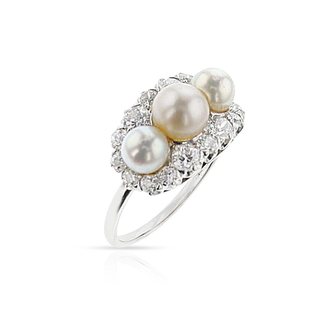 A Tiffany & Co. Art Deco Akoya Pearl and European-Cut Diamond Ring made in Platinum. The pearls measure 5.35 to 6.45 mm. The width of the band is 1.5mm wide, and the length is 11mm. There are 16 round European cut Diamonds, approx. 1.12ctw, SI1-I1