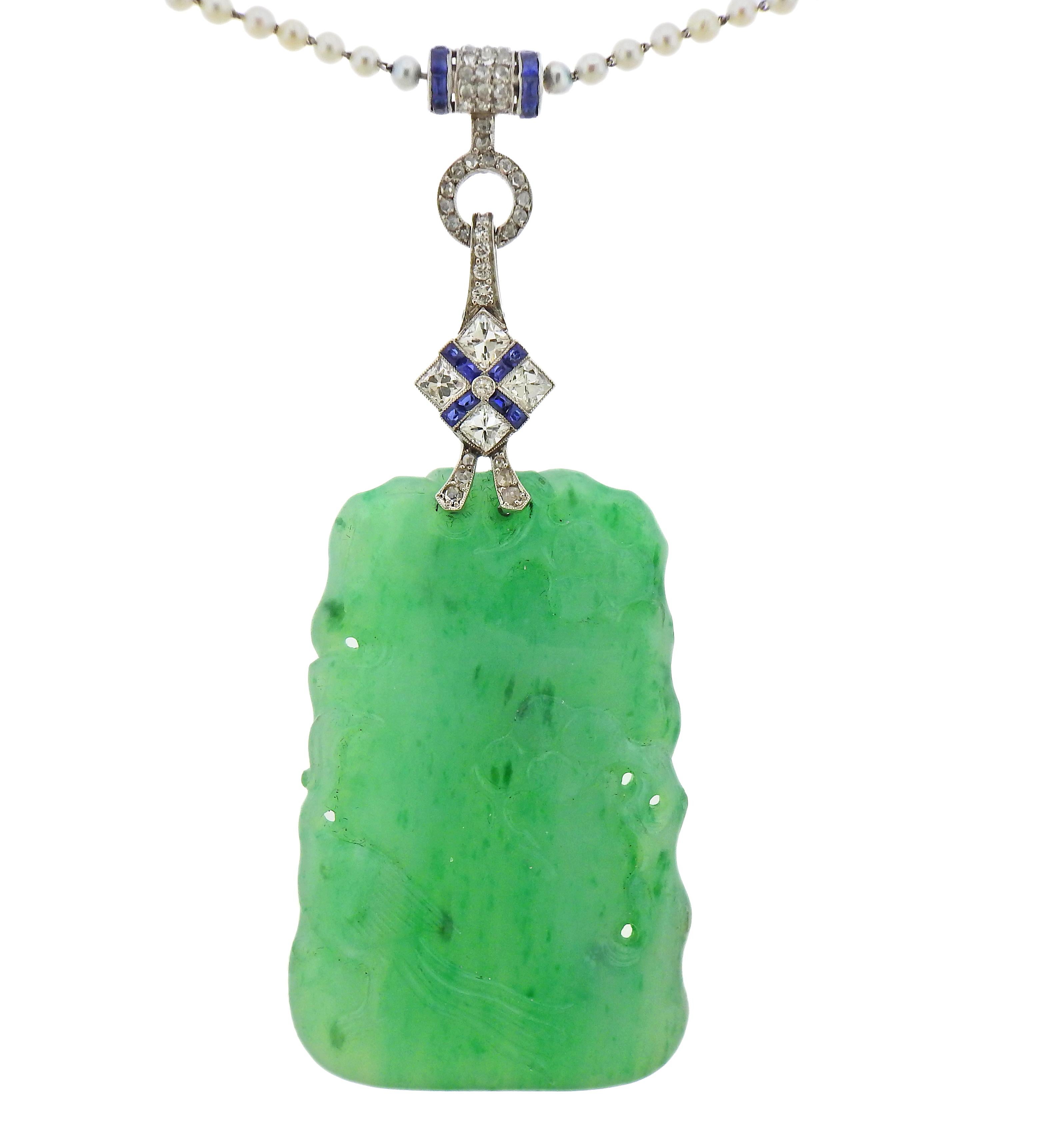 Art Deco platinum necklace with pendant, by Tiffany & Co, featuring carved jade2.5-3mm pearls, blue sapphires and approx. 3.00ctw in diamonds.  Jade in pendant measures 53mm x 35nn x 6.2mm, jade elements in the necklace measure 23mm x 6mm (as the