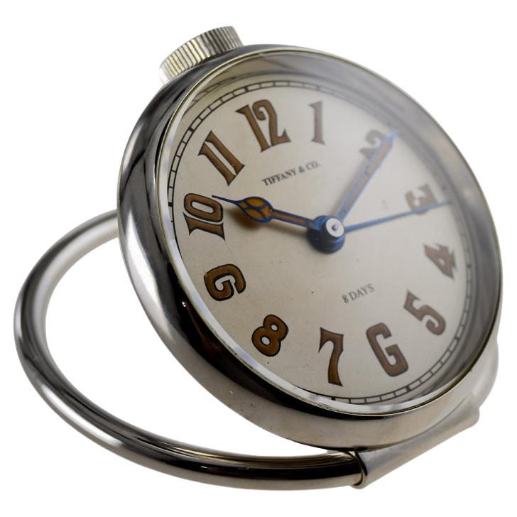 FACTORY / HOUSE: Tiffany & Co. by Concord
STYLE / REFERENCE: Alarm
METAL / MATERIAL: Nickel
CIRCA / YEAR: 1950's
DIMENSIONS / SIZE:  Length X Diameter
MOVEMENT / CALIBER: Manual Winding / 15 Jewels 
DIAL / HANDS: Silvered with Luminous Numerals /
