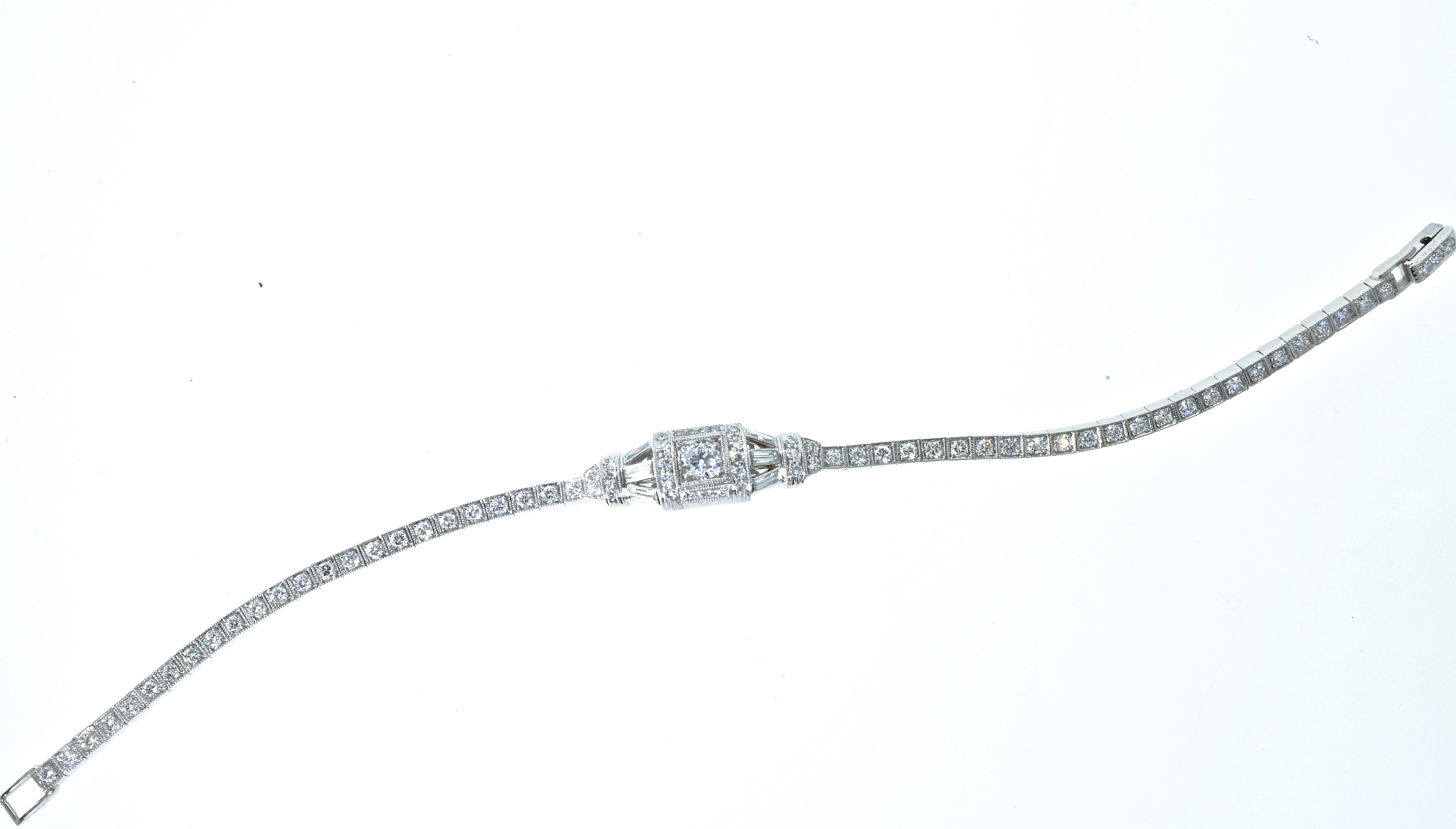 Tiffany & Co., platinum Art Deco diamond bracelet with 6 baguette cut diamonds in the center creating a geometric design continuing with round brilliant cut diamonds continuing down the sides of the bracelet.  There are 80 diamonds weighing slightly