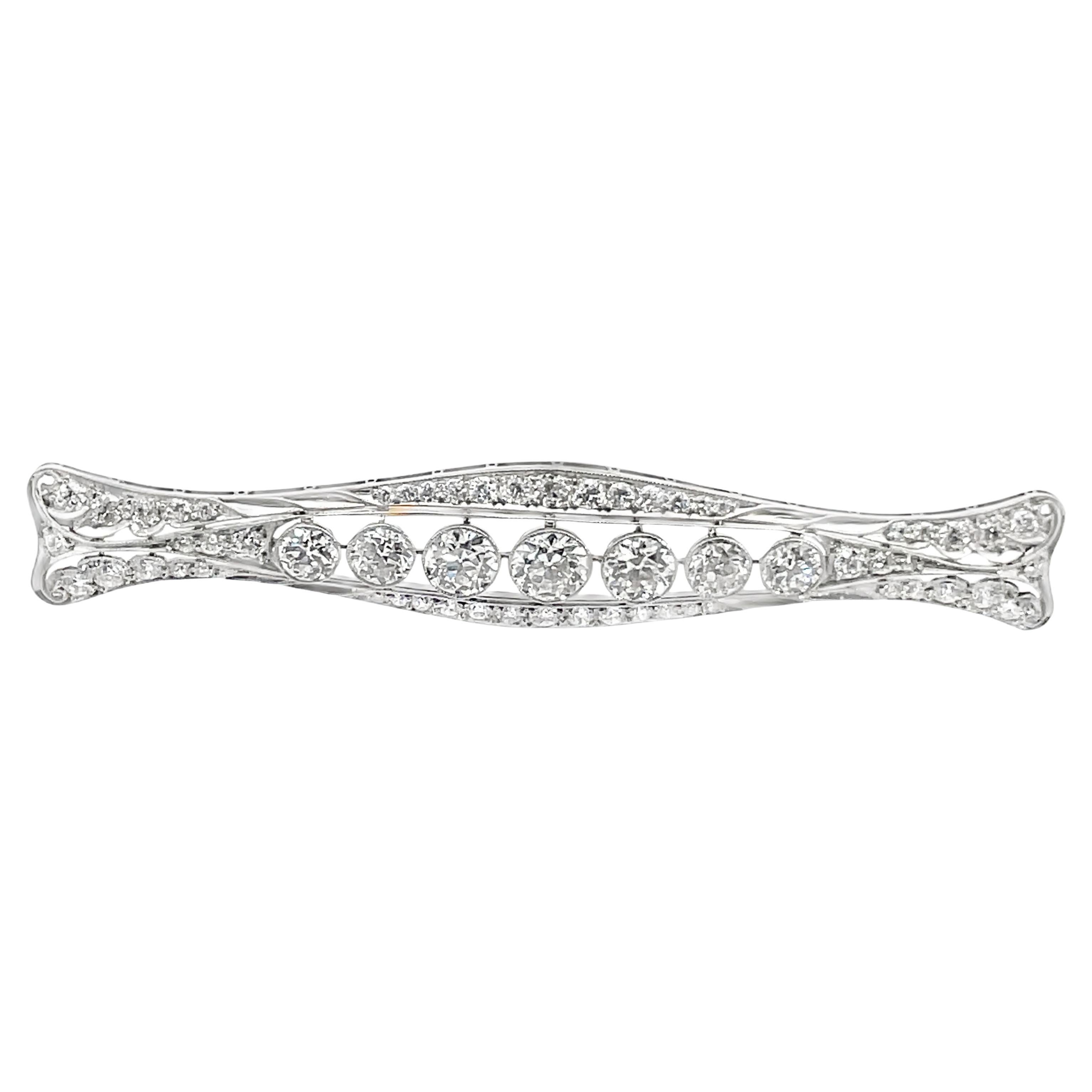 Platinum filigree diamond Art Deco brooch by Tiffany, circa 1920’s, is set with seven principal round cut brilliants and pave full cut diamonds, tw approx. 5.20 carats. The brooch measures 3″ x 1.5″ and is signed and accompanied by a box and a 