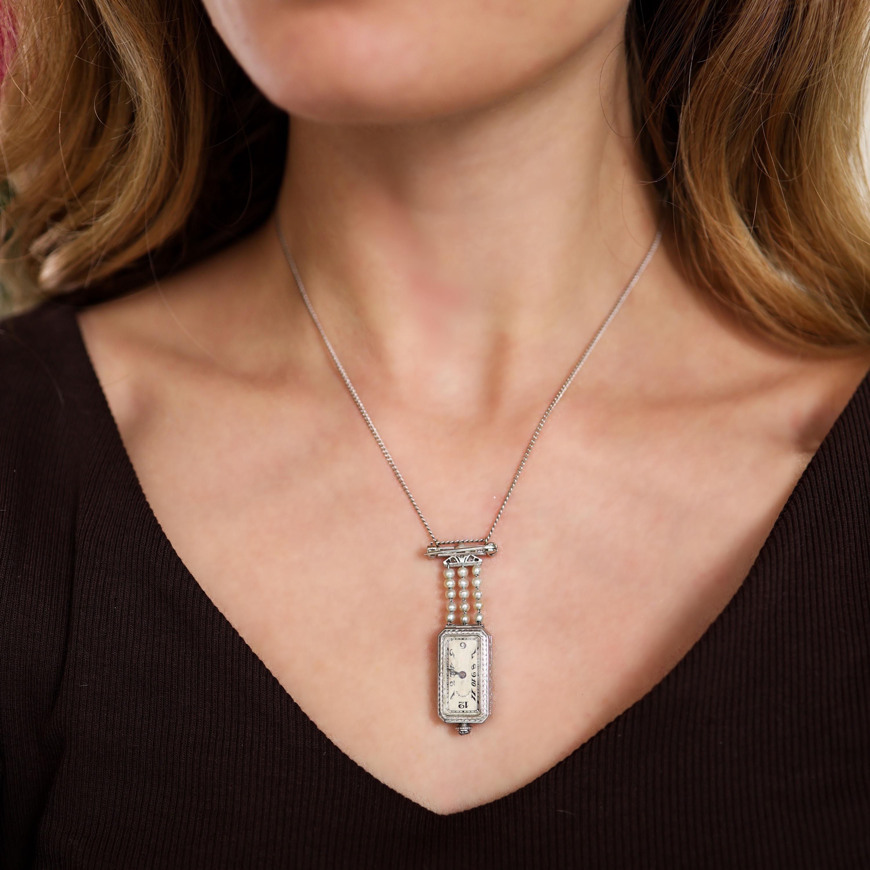 Please note that the movement is currently not working and is due to be repaired.

A Tiffany & Co., Art Deco, diamond, pearl and platinum lapel pendant watch, with a diamond set platinum bar pin, with safety catch fitting, with larger diamonds in