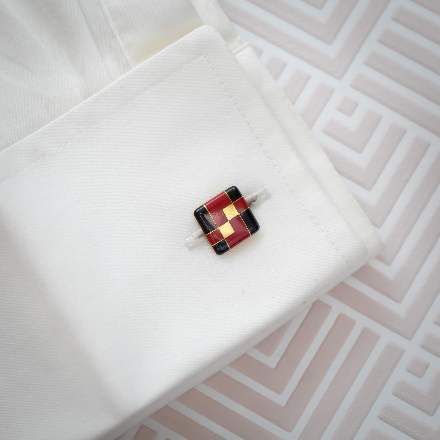 A pair of red and black enamel on gold cufflinks, with geometric designs. One bar is signed Tiffany & Co. With French eagle marks for 18ct gold and maker's marks, circa 1925.